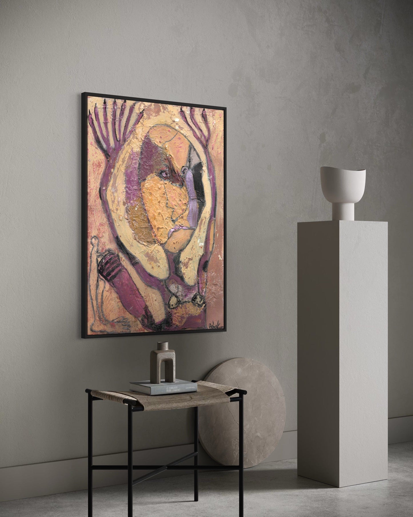 Abstract painting on a wall in a modern interior setting with a small table and decorative items.