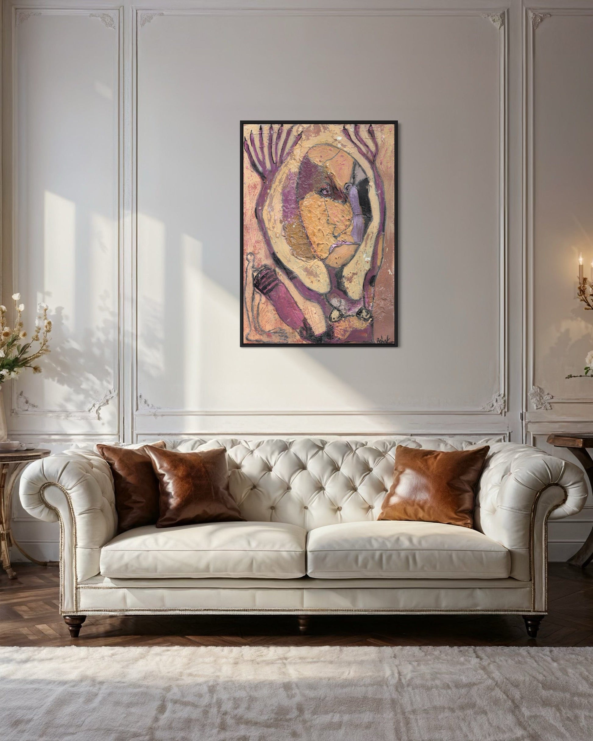 White tufted sofa with brown cushions in a room with decorative wall art.