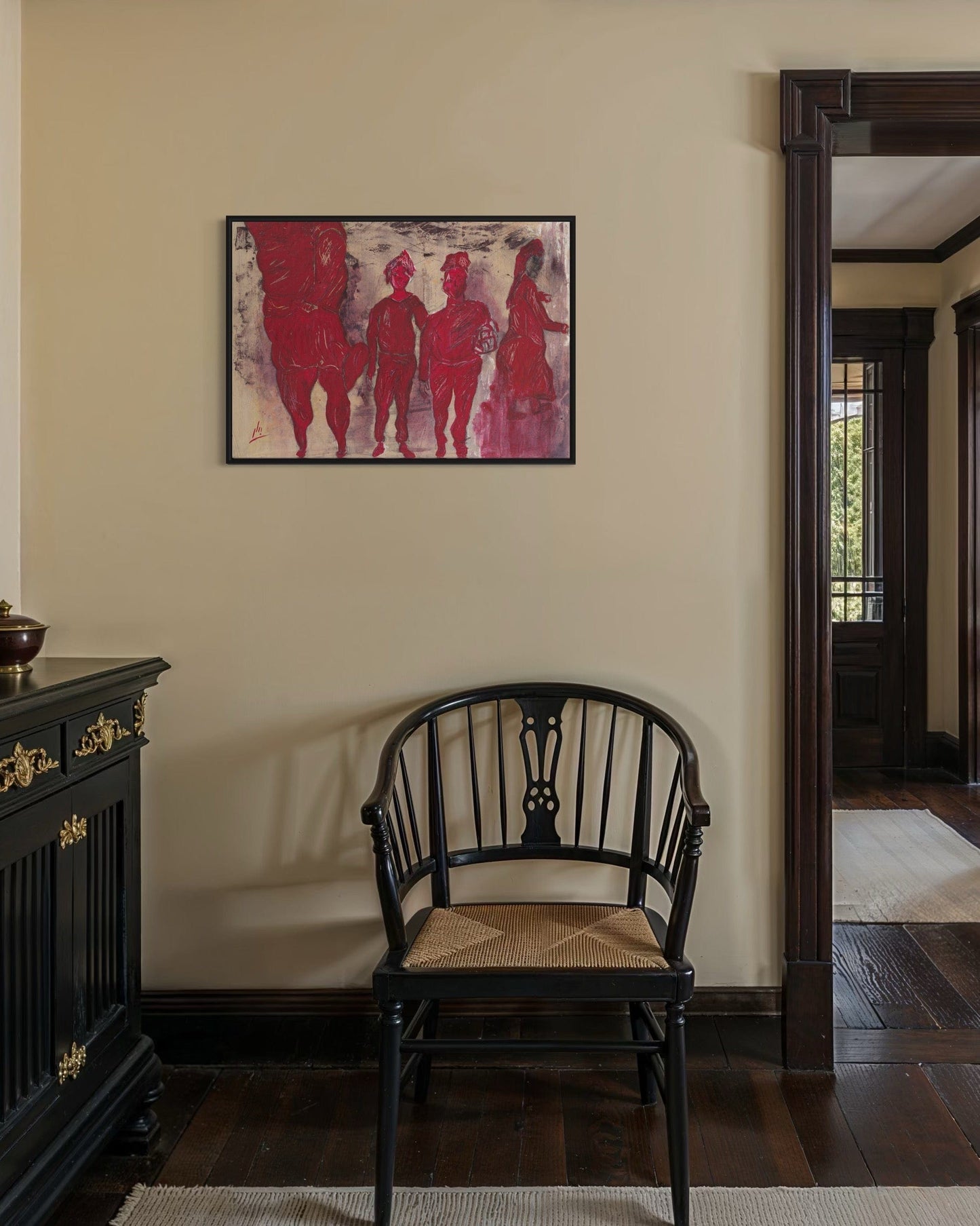 Chair in a room with a framed artwork on the wall