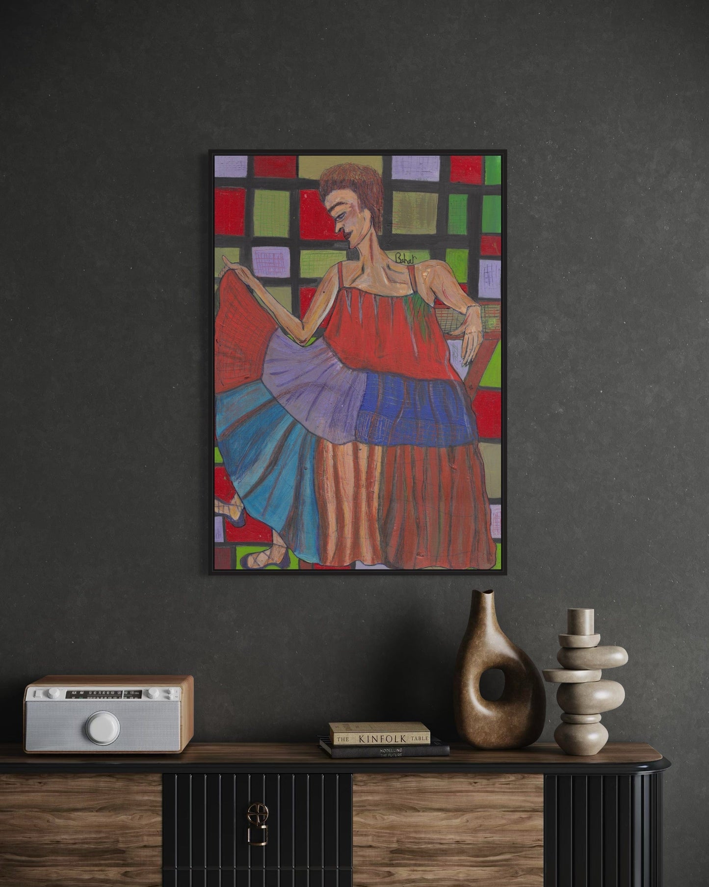 Colorful abstract painting of a woman on a dark wall above a wooden console table.