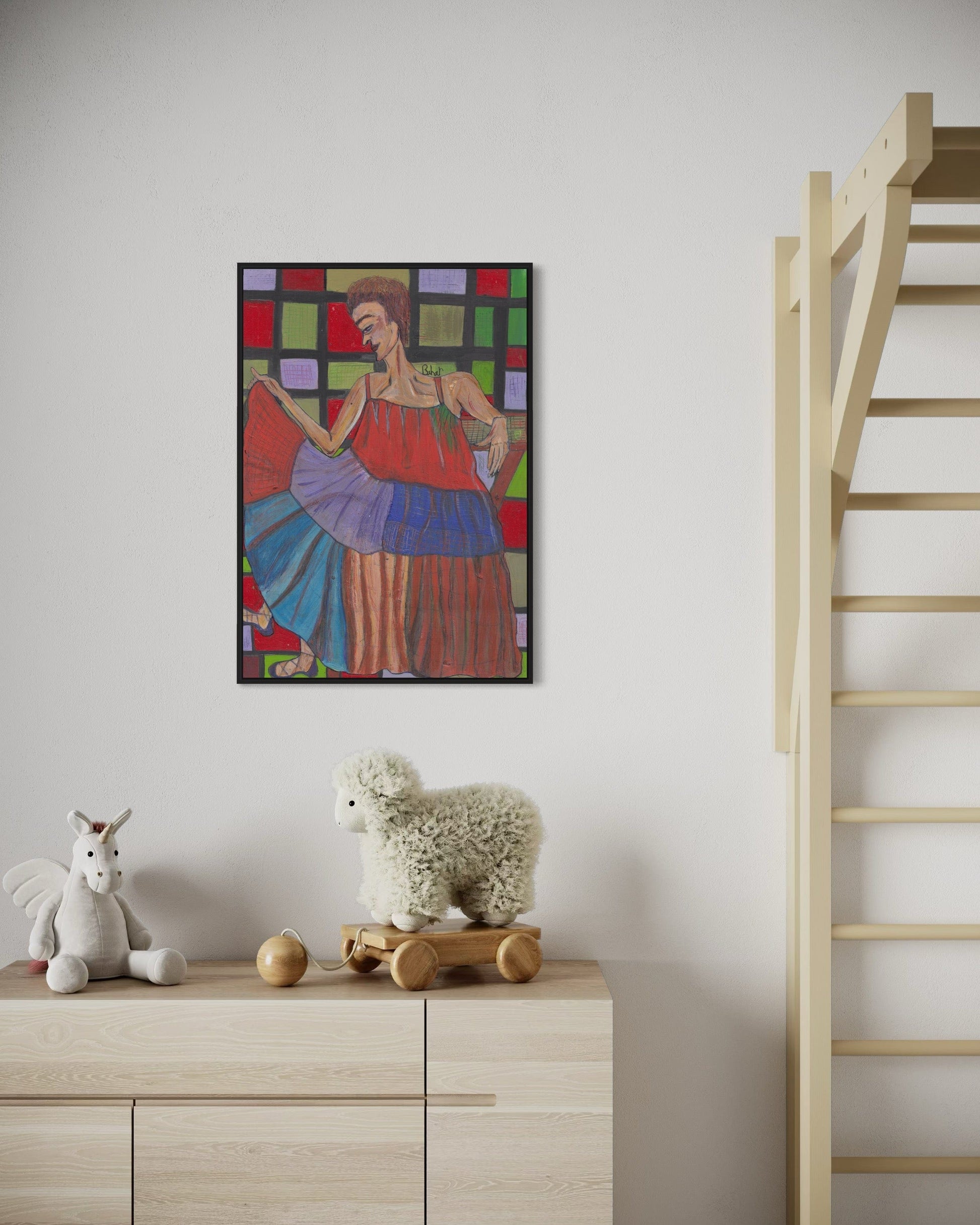 Colorful abstract painting on a wall above a wooden cabinet with toys.