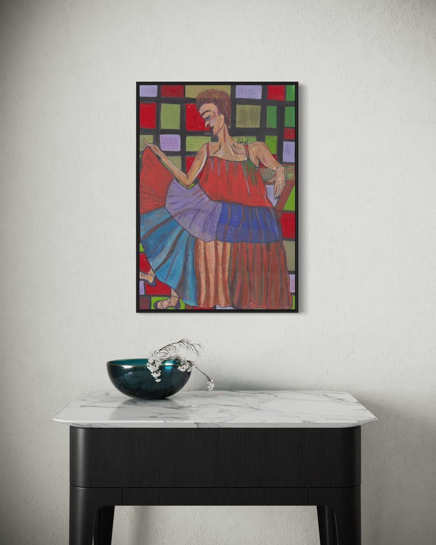 Colorful abstract painting of a woman on a wall above a marble table with a decorative bowl.