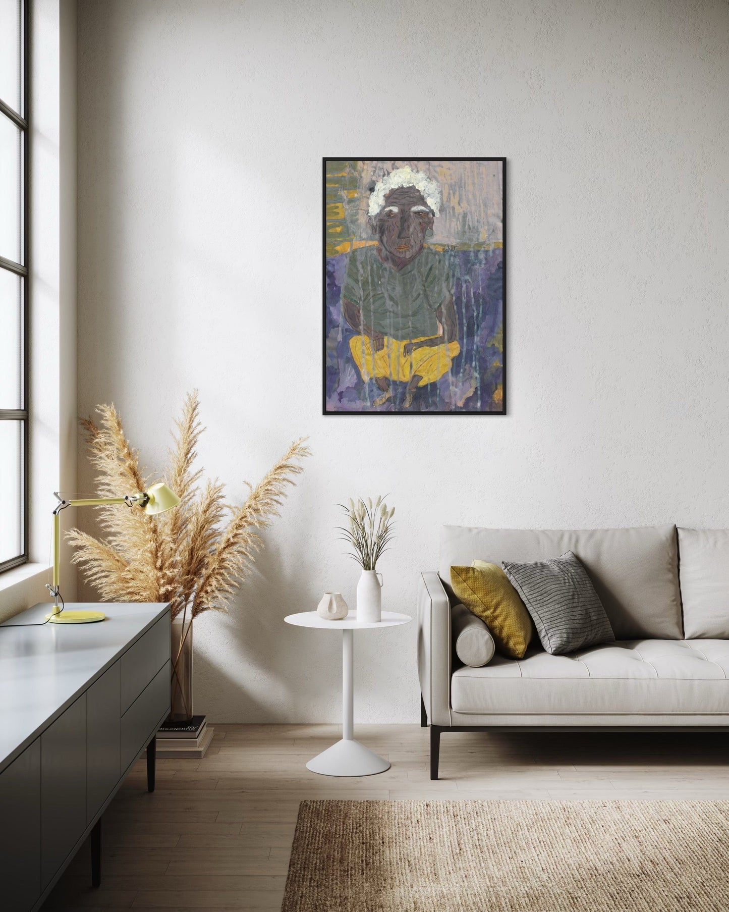 Modern living room with a painting on the wall, a sofa, and decorative elements.