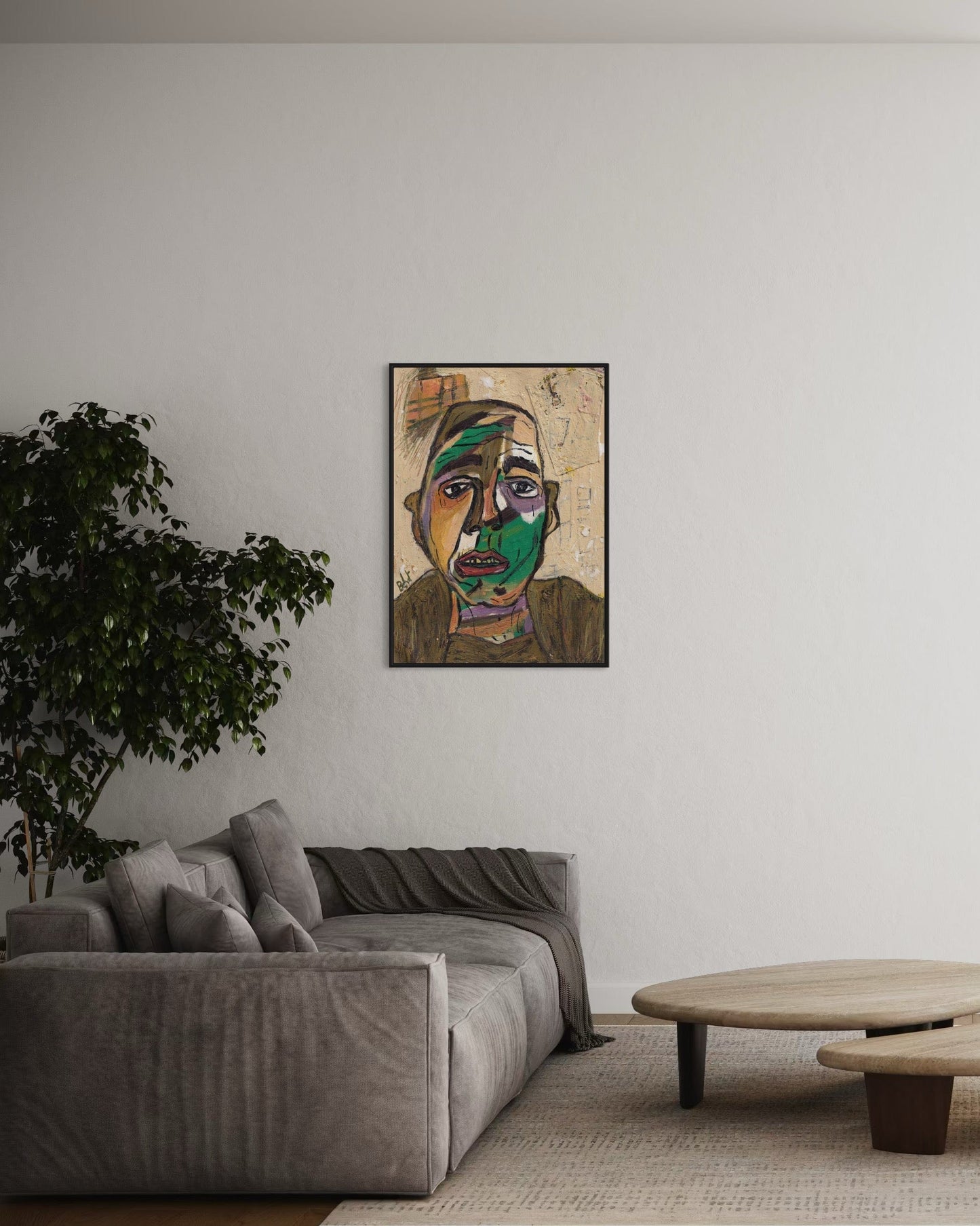 Living room with a gray sofa, round wooden coffee table, and a framed artwork on the wall.