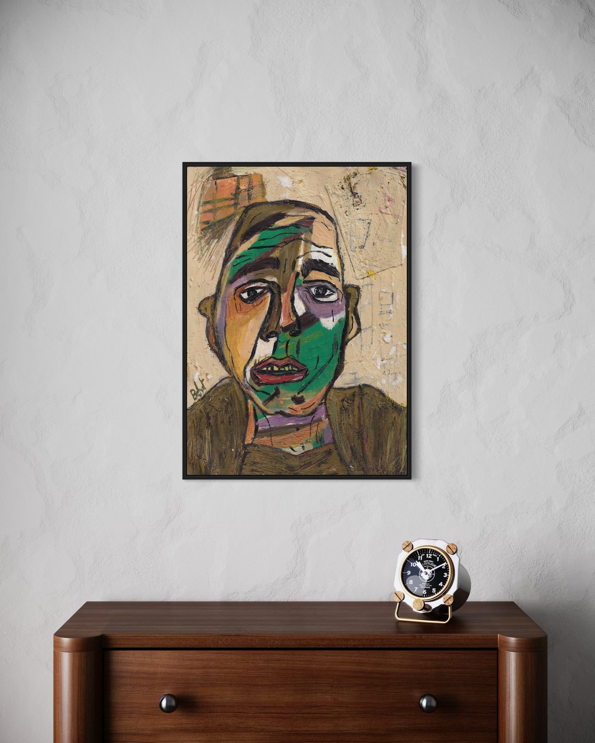 Abstract art portrait on a wall above a wooden dresser with a clock.