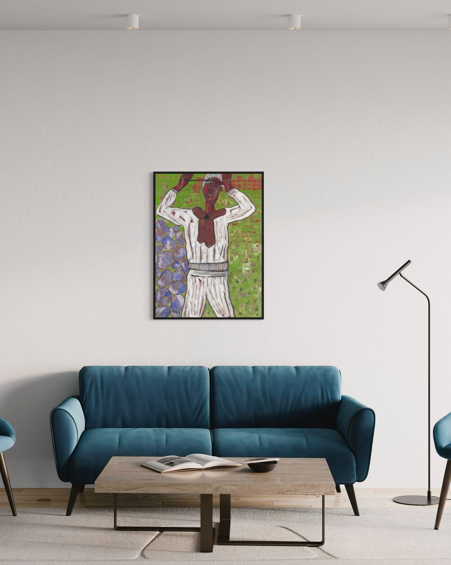 Modern living room with a blue sofa, wooden coffee table, and framed artwork on the wall.