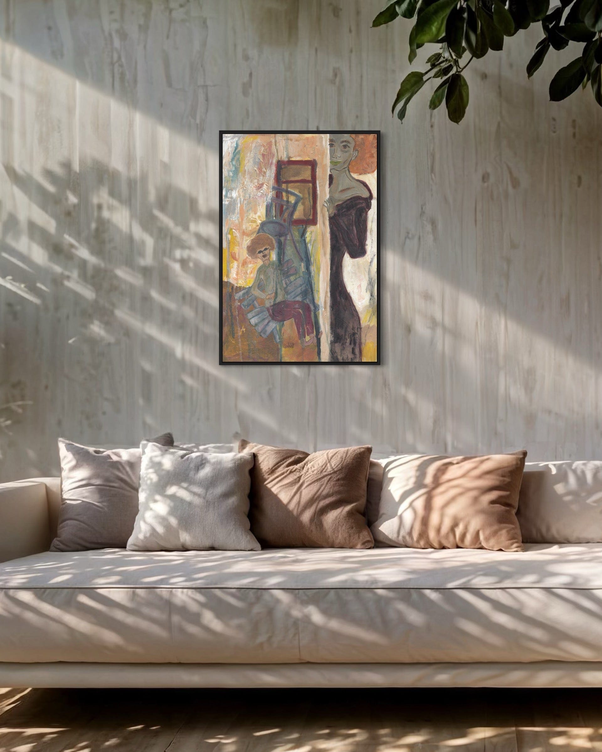 Framed artwork above a sofa with pillows in a room with sunlight filtering through.