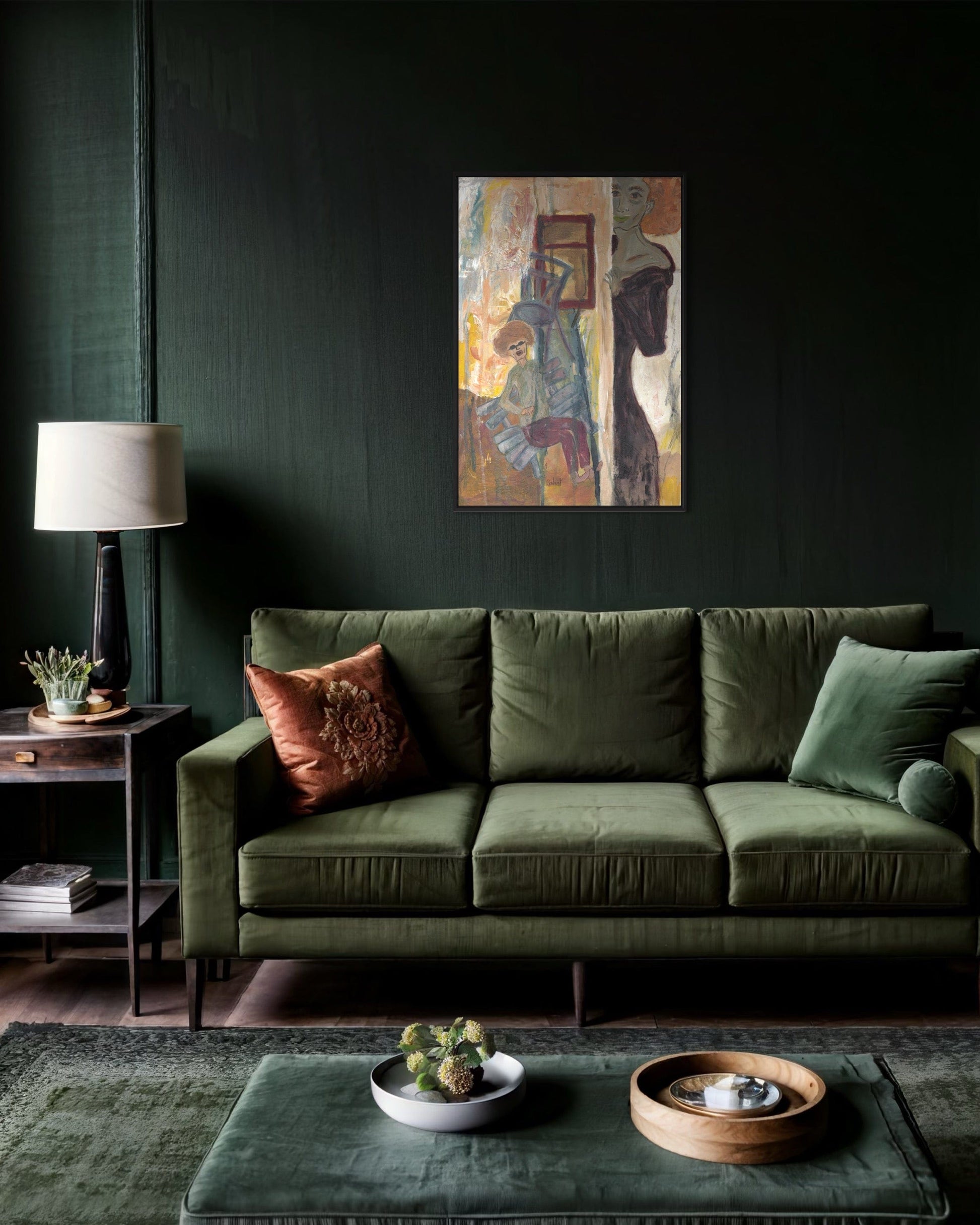 Green sofa in a living room with a dark wall, abstract painting, and decorative items.