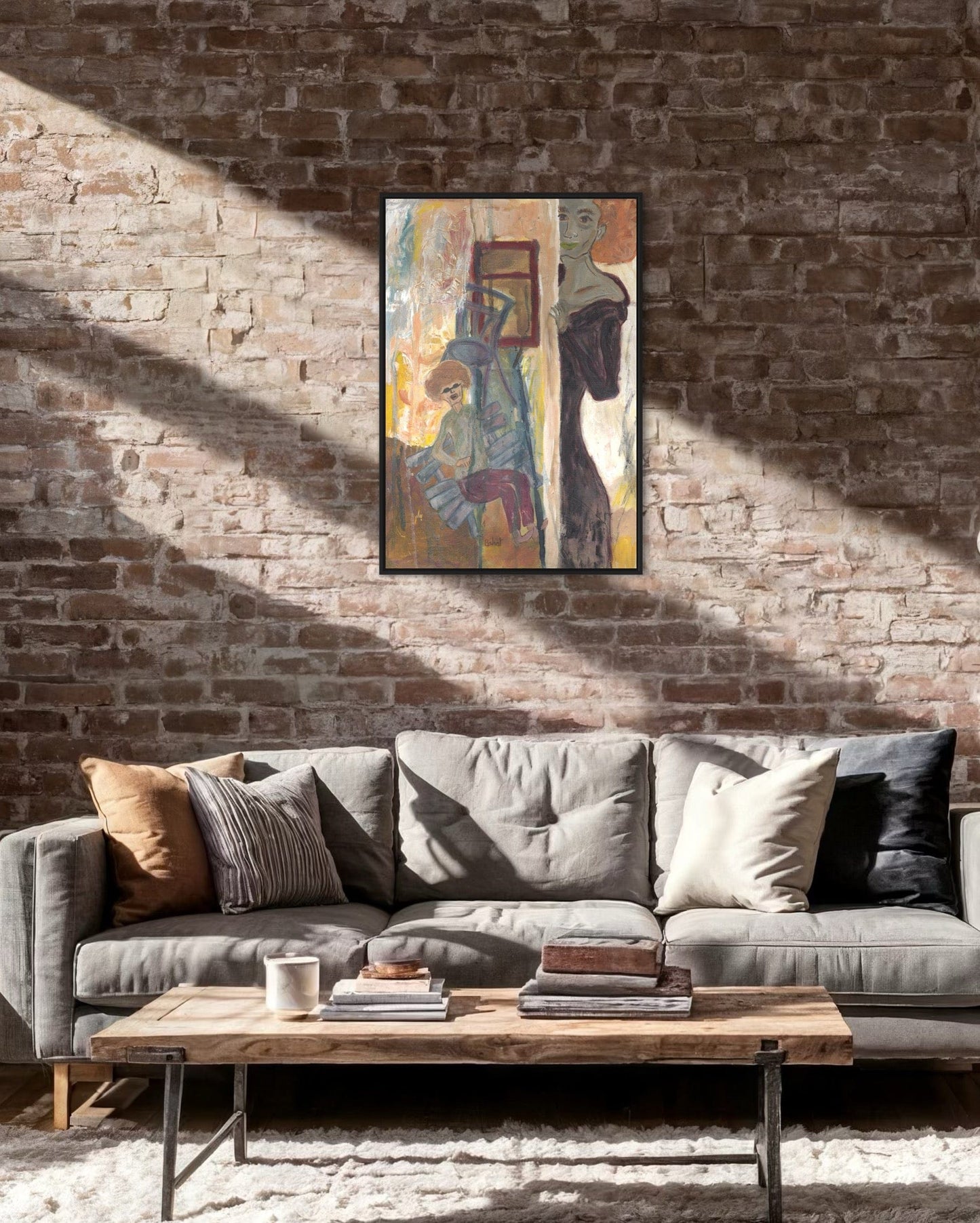 Gray sofa with decorative pillows in a room with a brick wall and abstract painting.