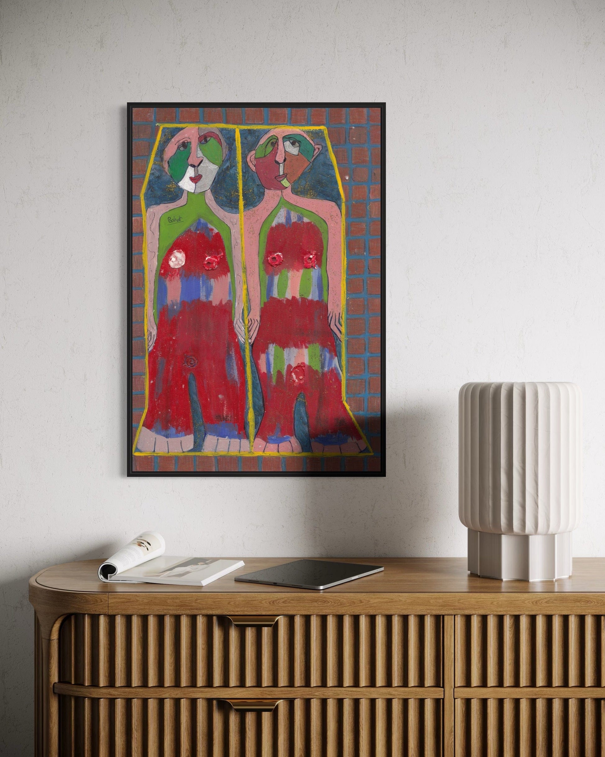 Colorful abstract painting on a wall above a wooden console table.
