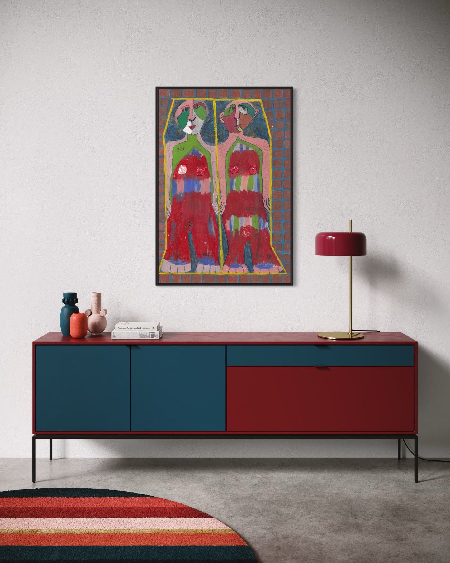 Modern interior with a red and blue sideboard, colorful rug, and abstract painting.