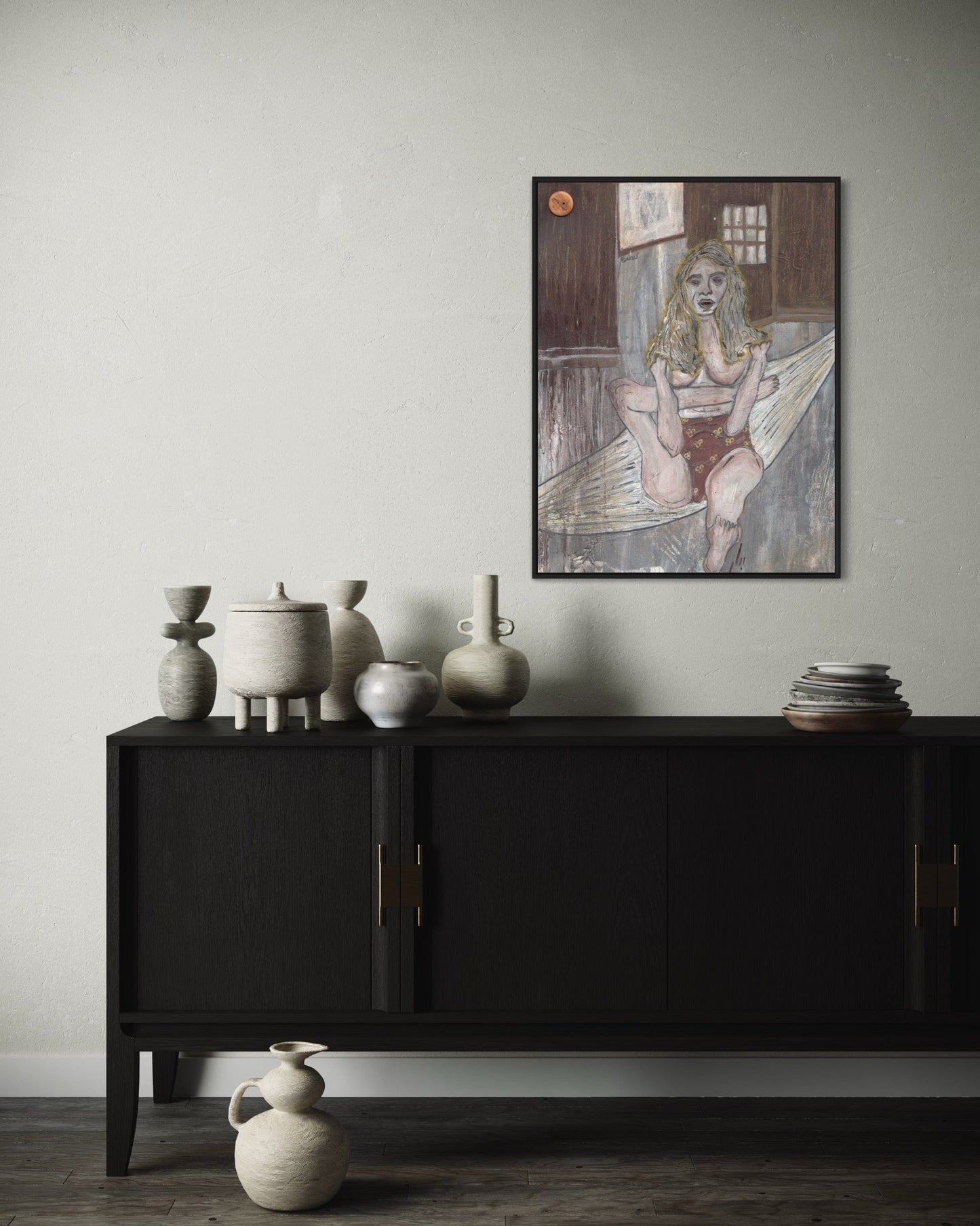 Black cabinet with decorative vases against a light gray wall with a framed artwork.