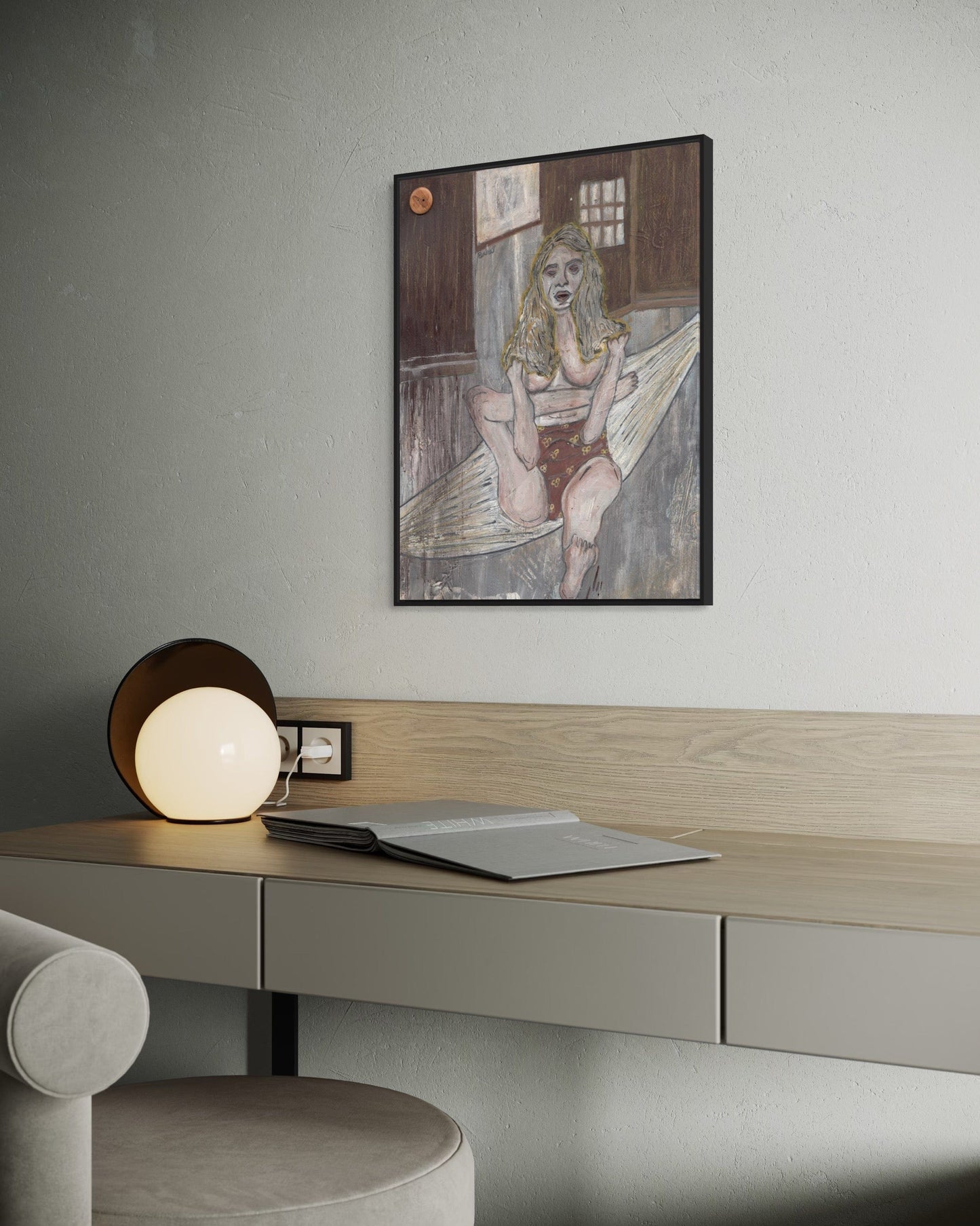 Desk with a lamp and a framed artwork on a wall