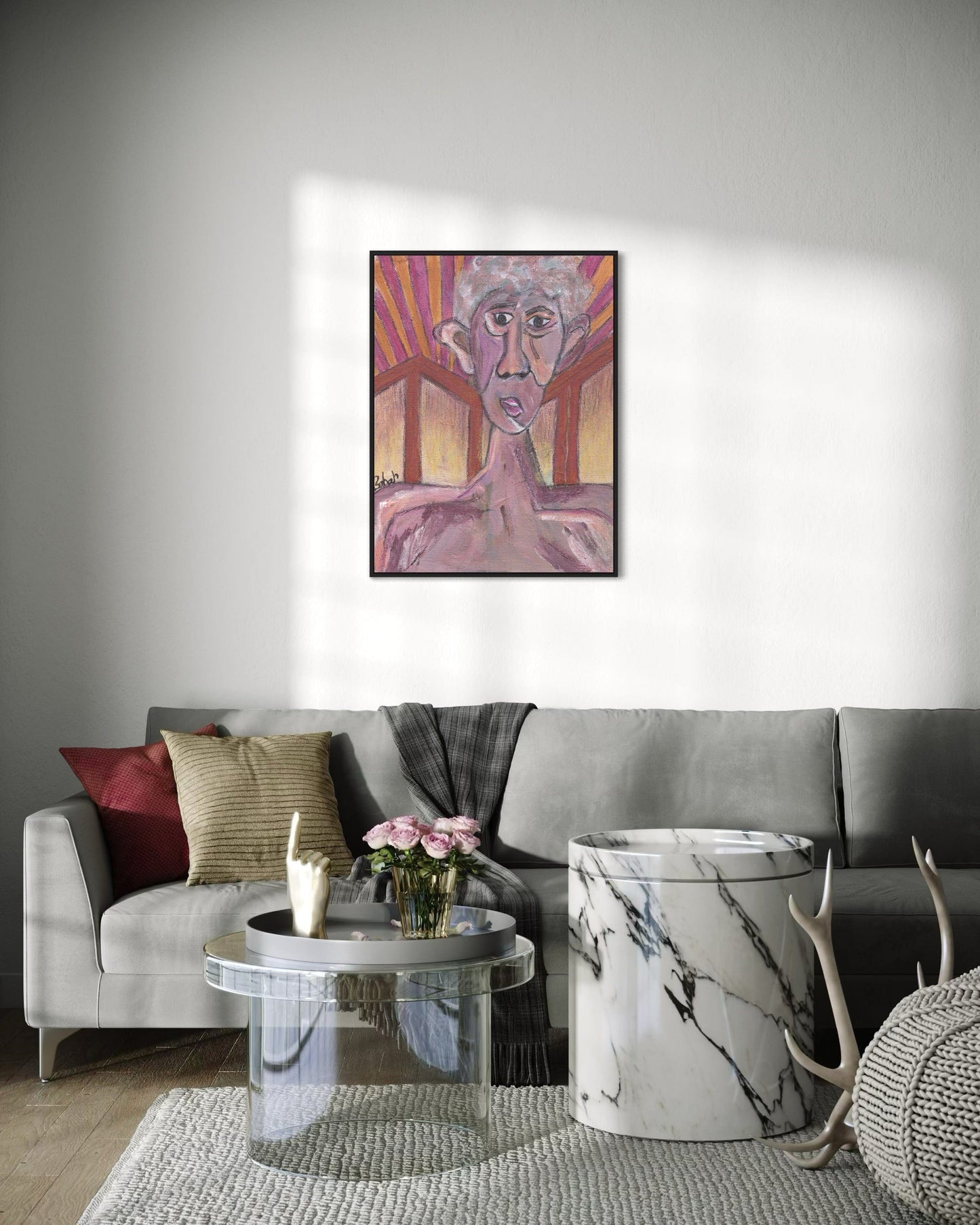Living room with a gray sofa, coffee table, and decorative items, featuring a colorful abstract painting on the wall.