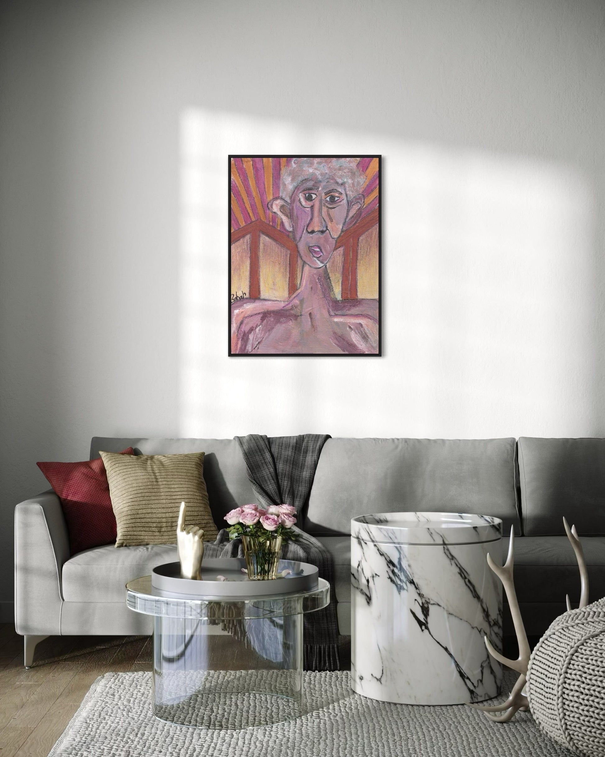 Living room with a gray sofa, coffee table, and decorative items, featuring a colorful abstract painting on the wall.