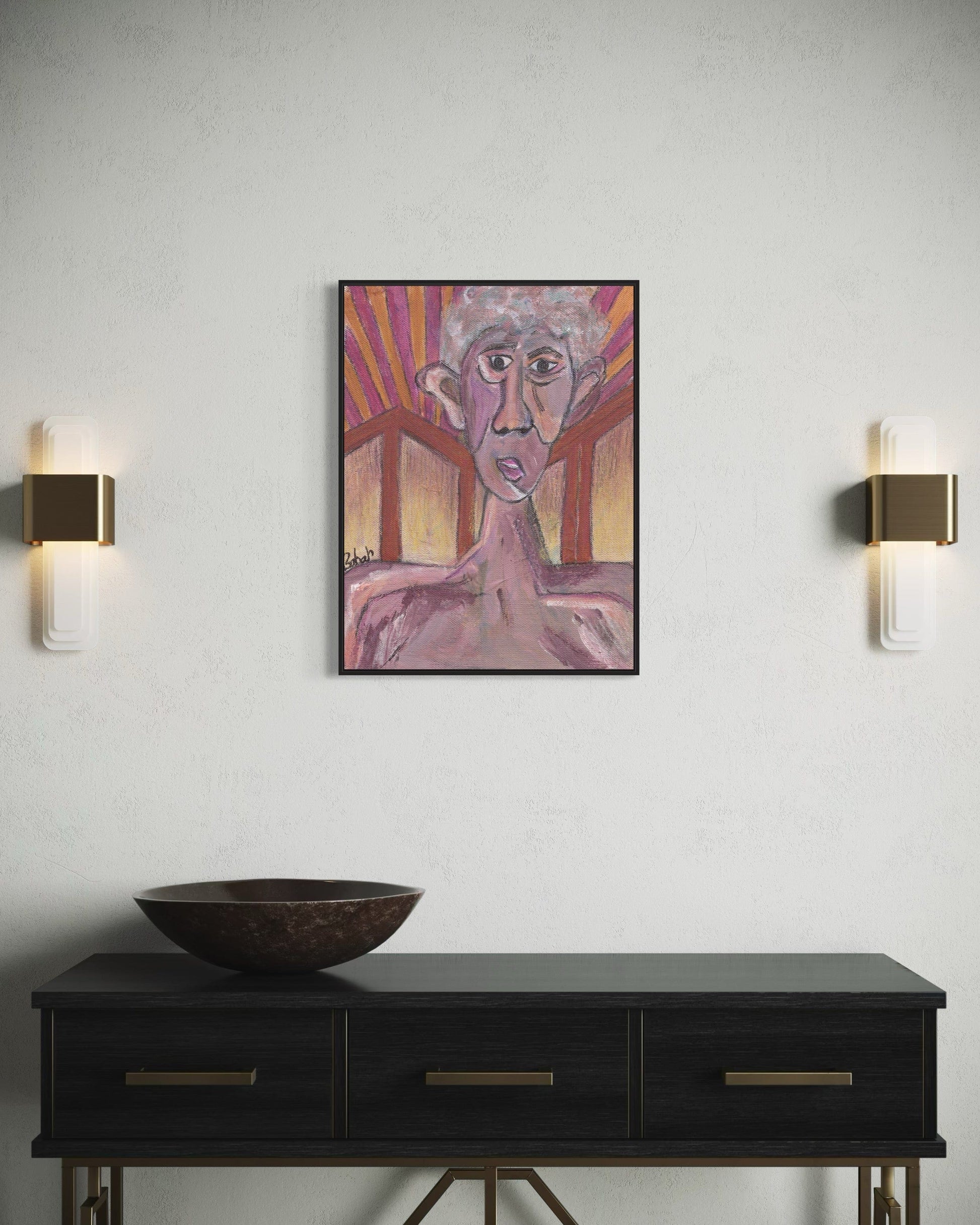 Framed artwork above a black console table with wall sconces on a light gray wall.