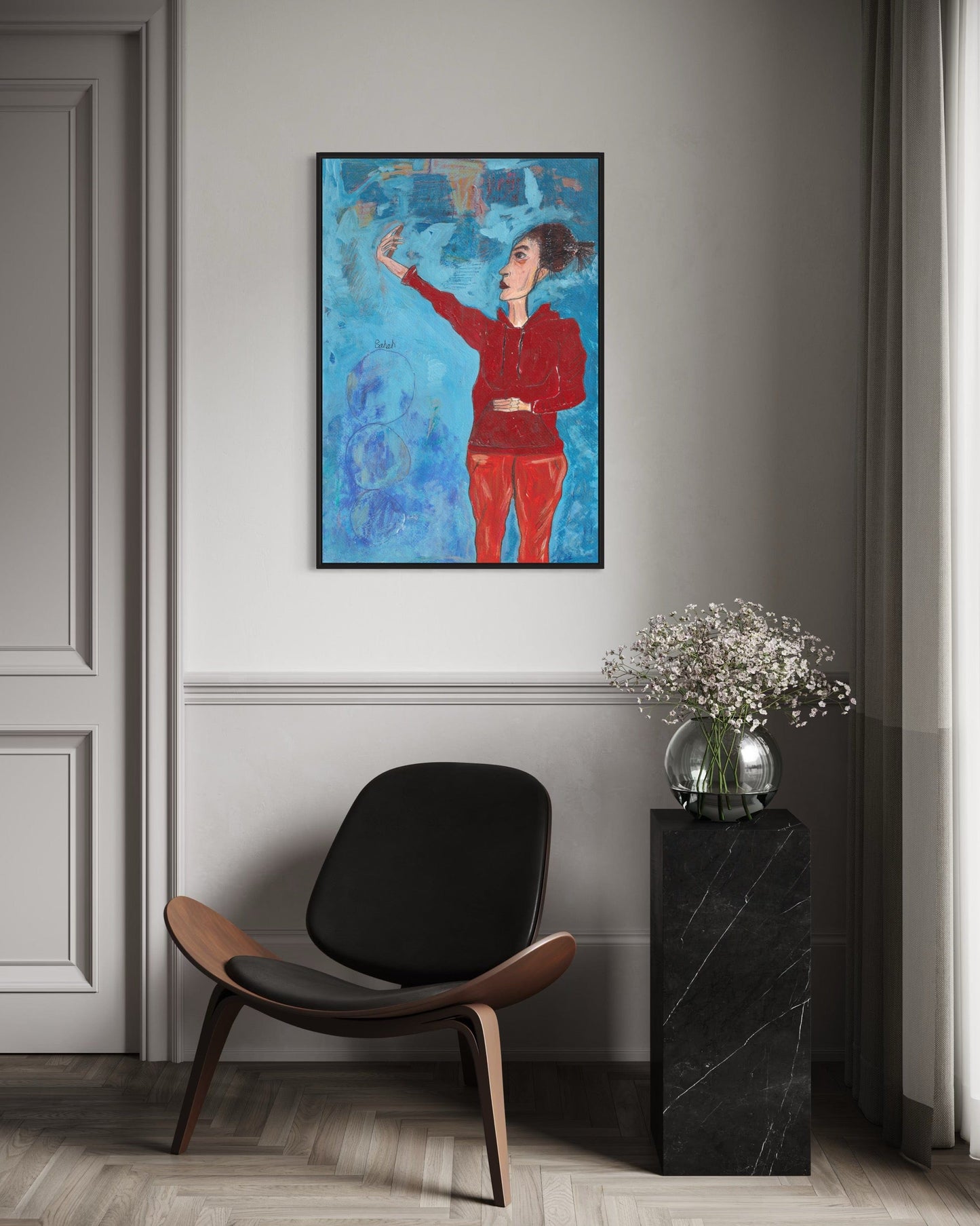 Modern interior with a colorful abstract painting, black chair, and black side table with flowers.