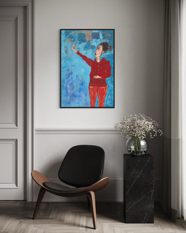 Modern interior with a colorful abstract painting, black chair, and black side table with flowers.