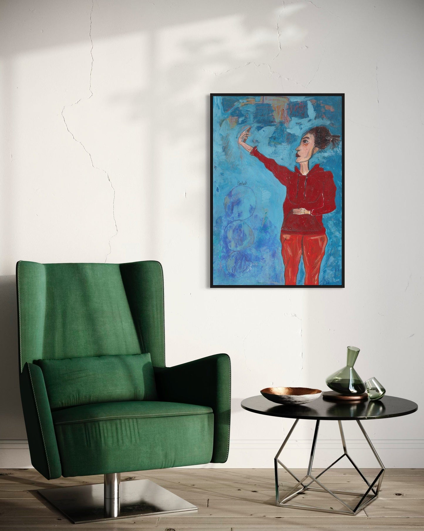 Green armchair in a room with a colorful abstract painting on the wall.