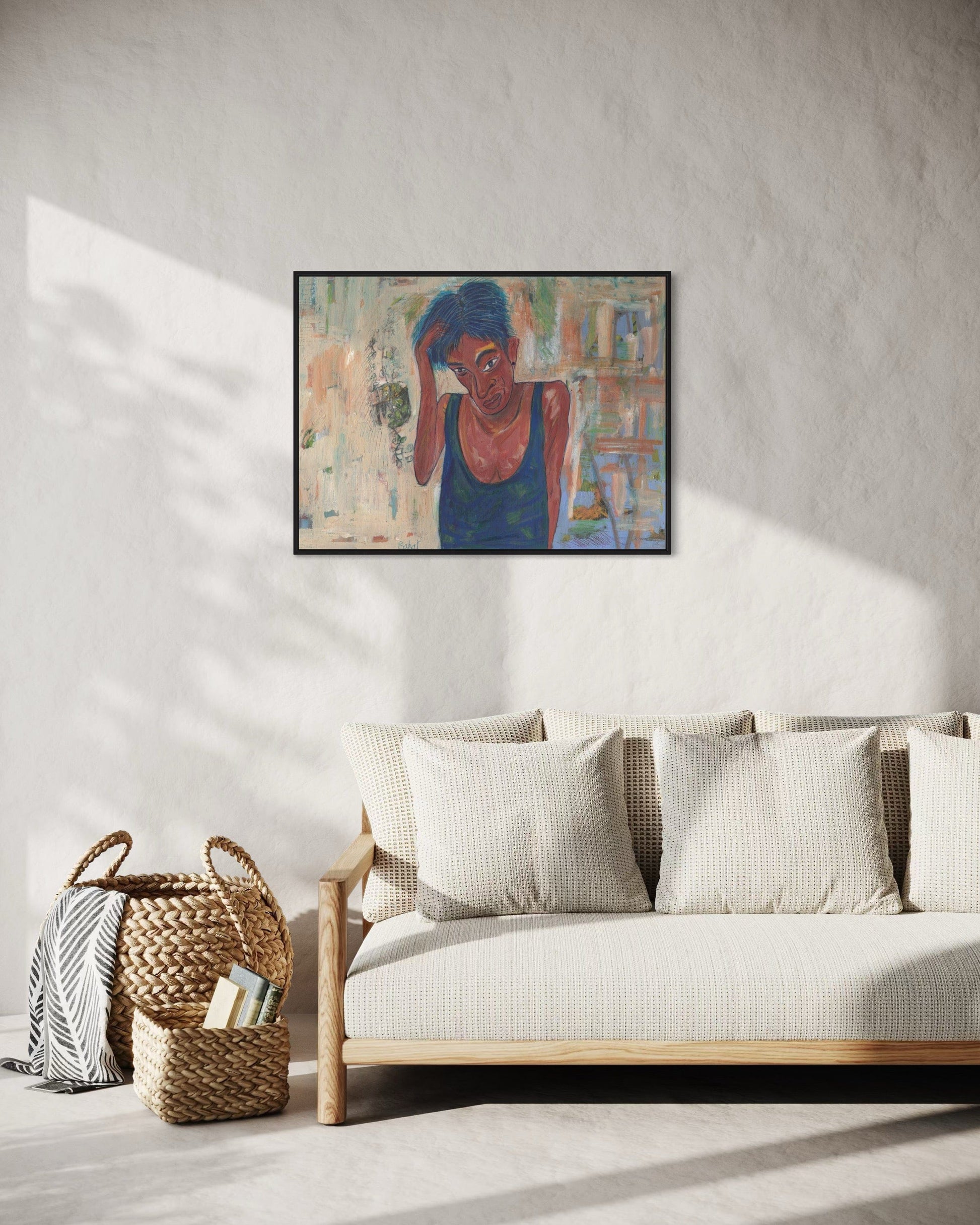 Framed artwork on a wall above a sofa in a living room