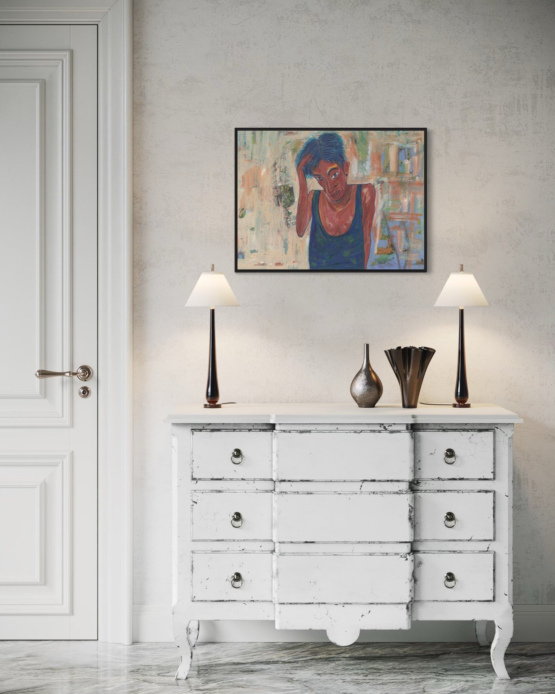 White distressed dresser with two lamps and a framed painting on a gray wall.