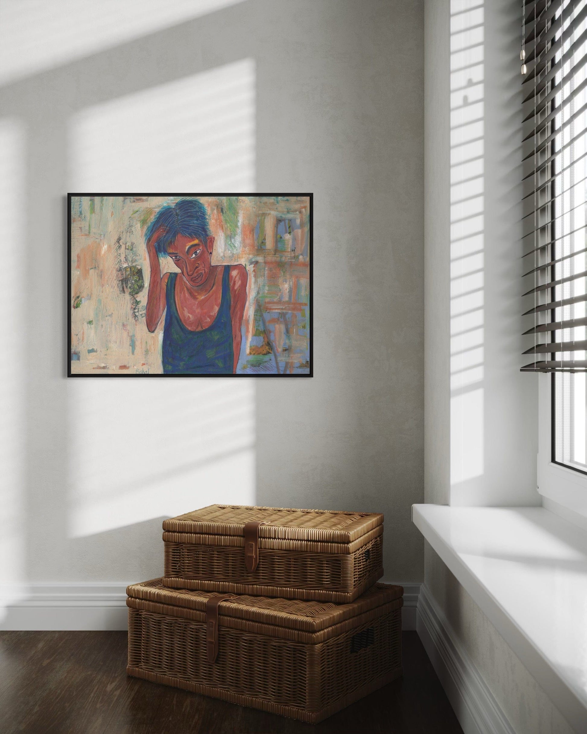 Framed artwork on a wall with wicker storage baskets on the floor below.