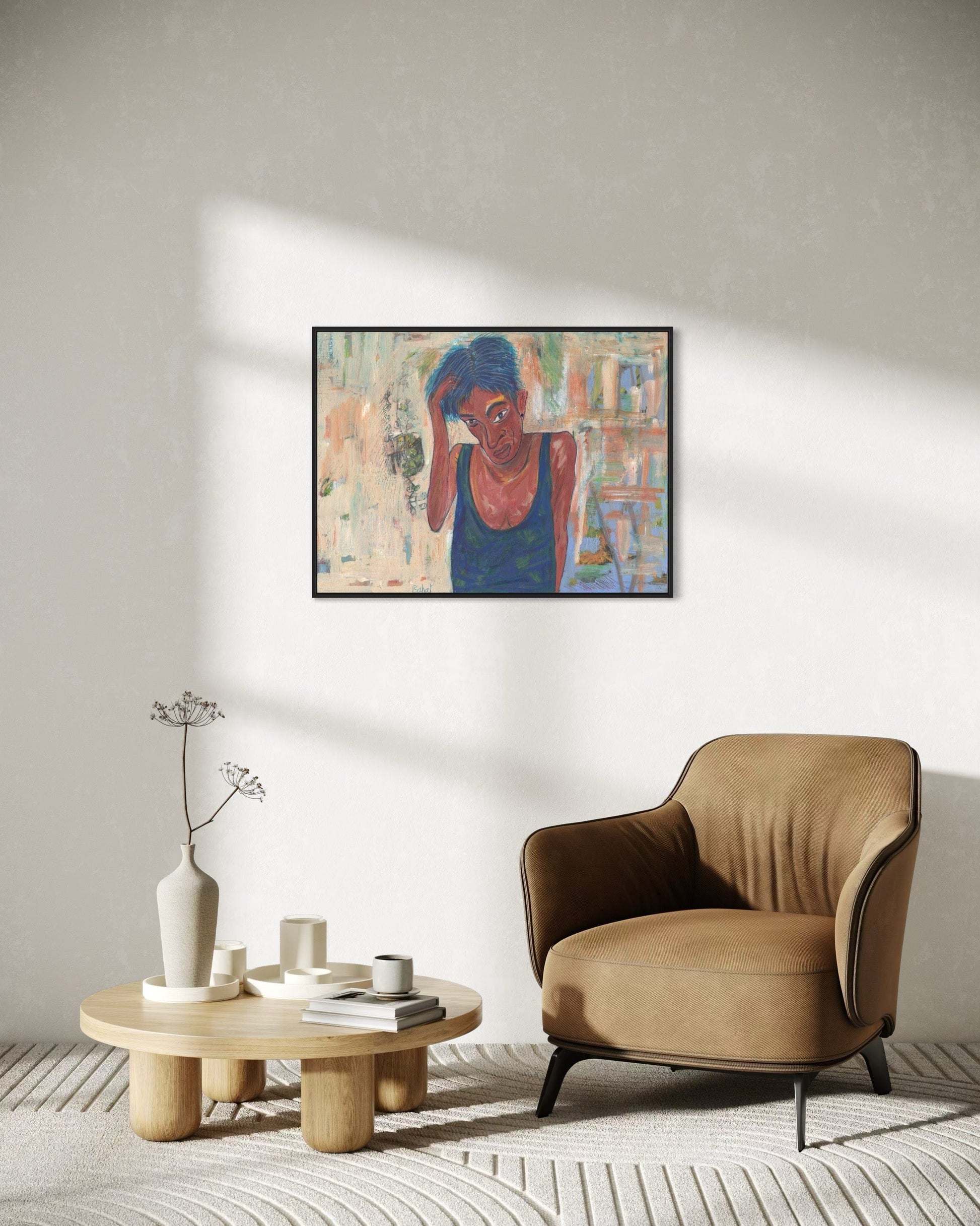 Modern living room with a beige armchair, wooden coffee table, and abstract painting on the wall.