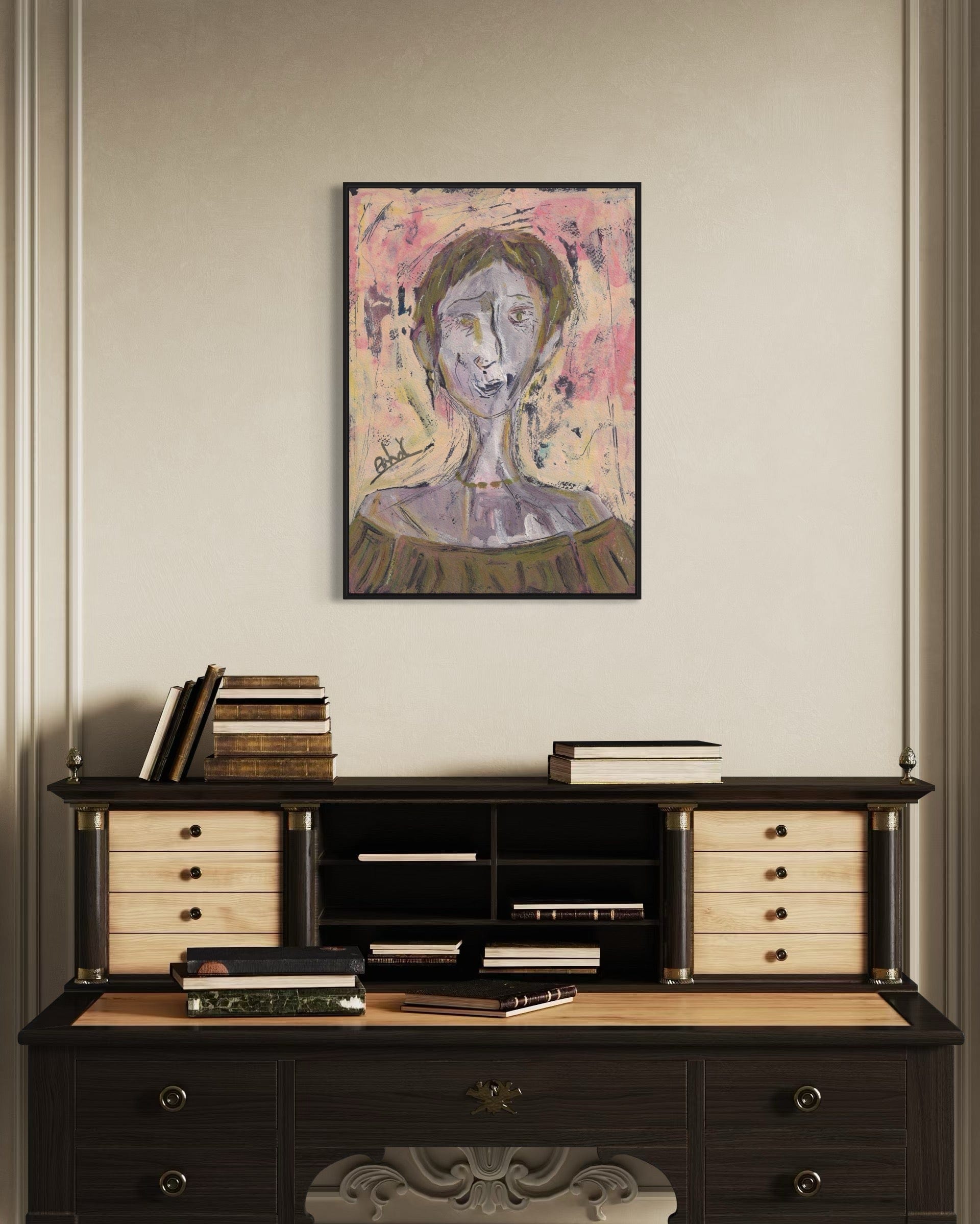 Dark wooden desk with drawers and books, above which is a framed abstract painting on a beige wall.
