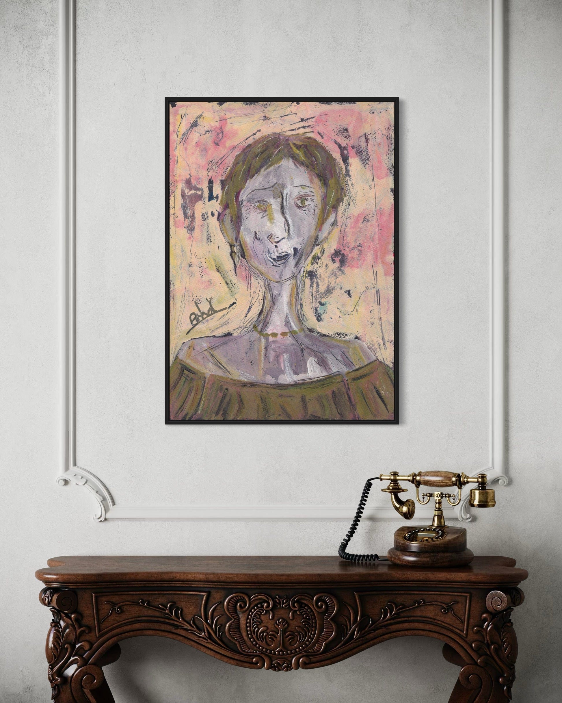 Framed abstract portrait above a wooden console table with a vintage telephone.