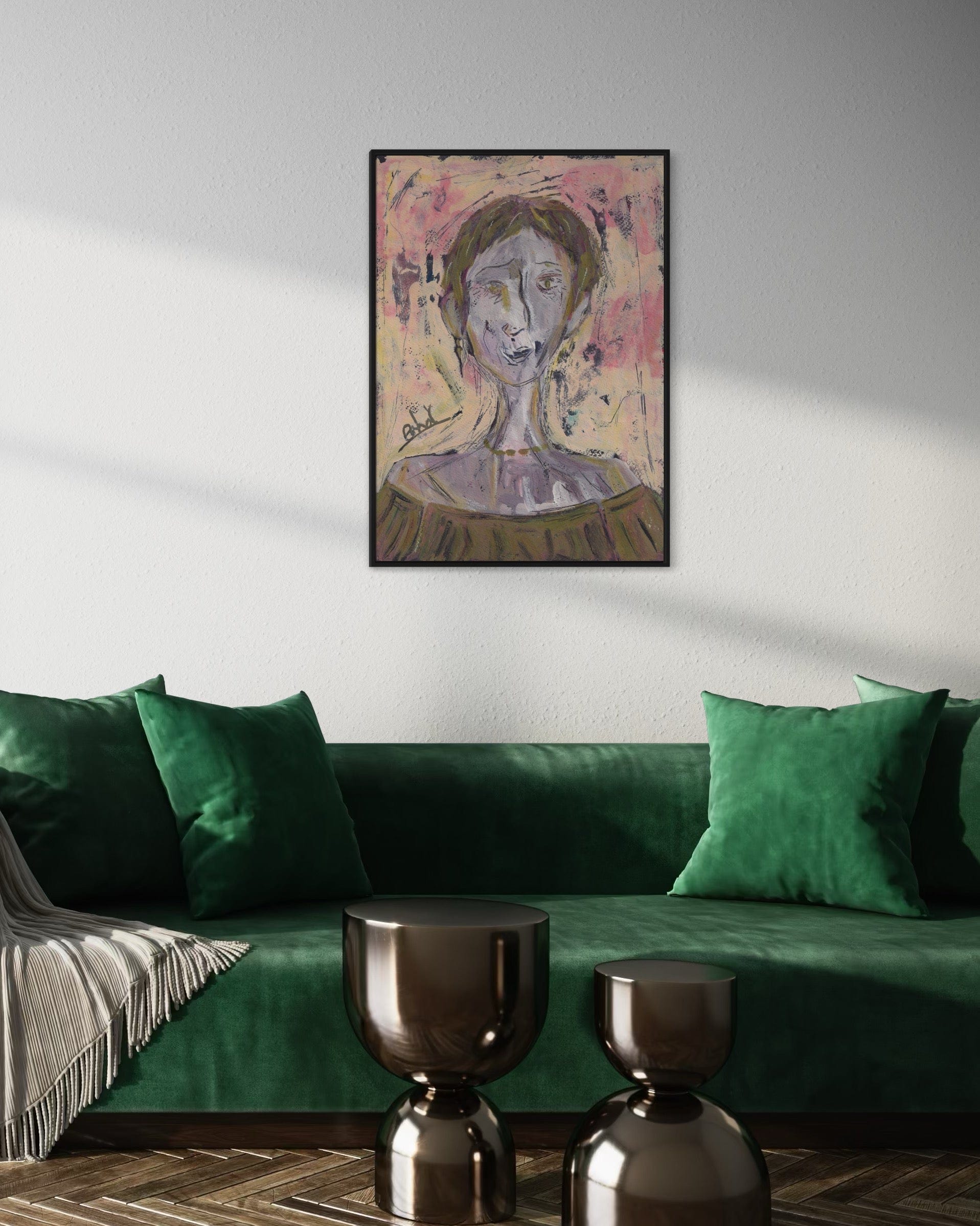 Green sofa with decorative pillows and a framed painting on a wall in a living room.