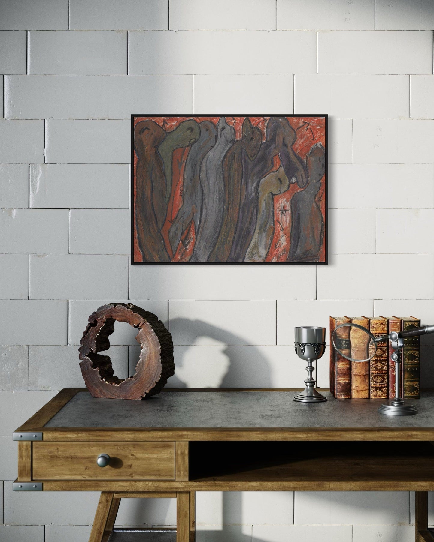 Abstract painting on a wall above a wooden desk with decorative items.