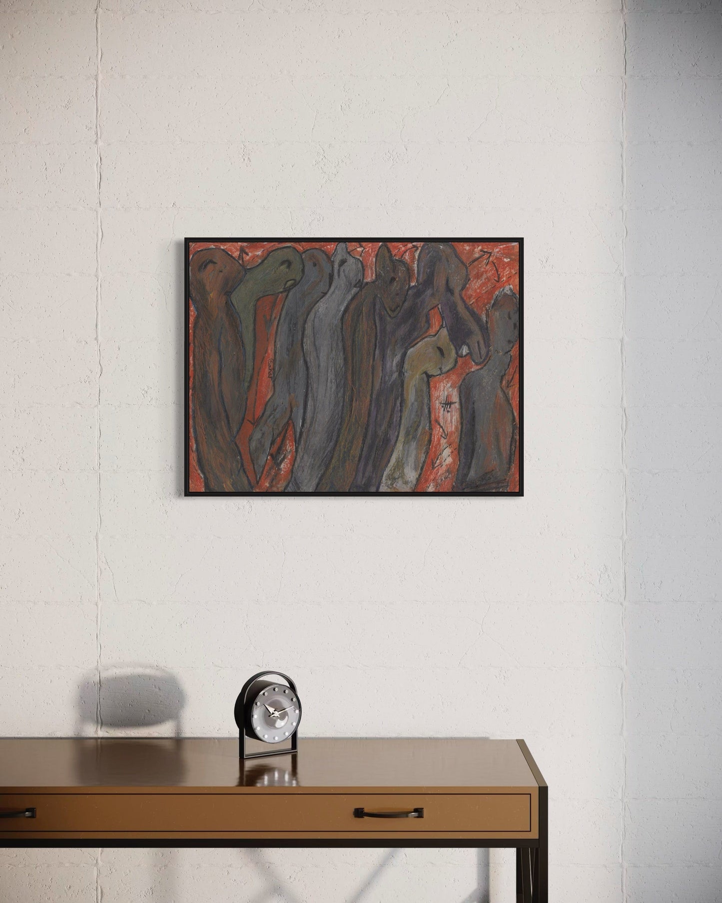 Abstract painting on a wall above a wooden desk with a clock.
