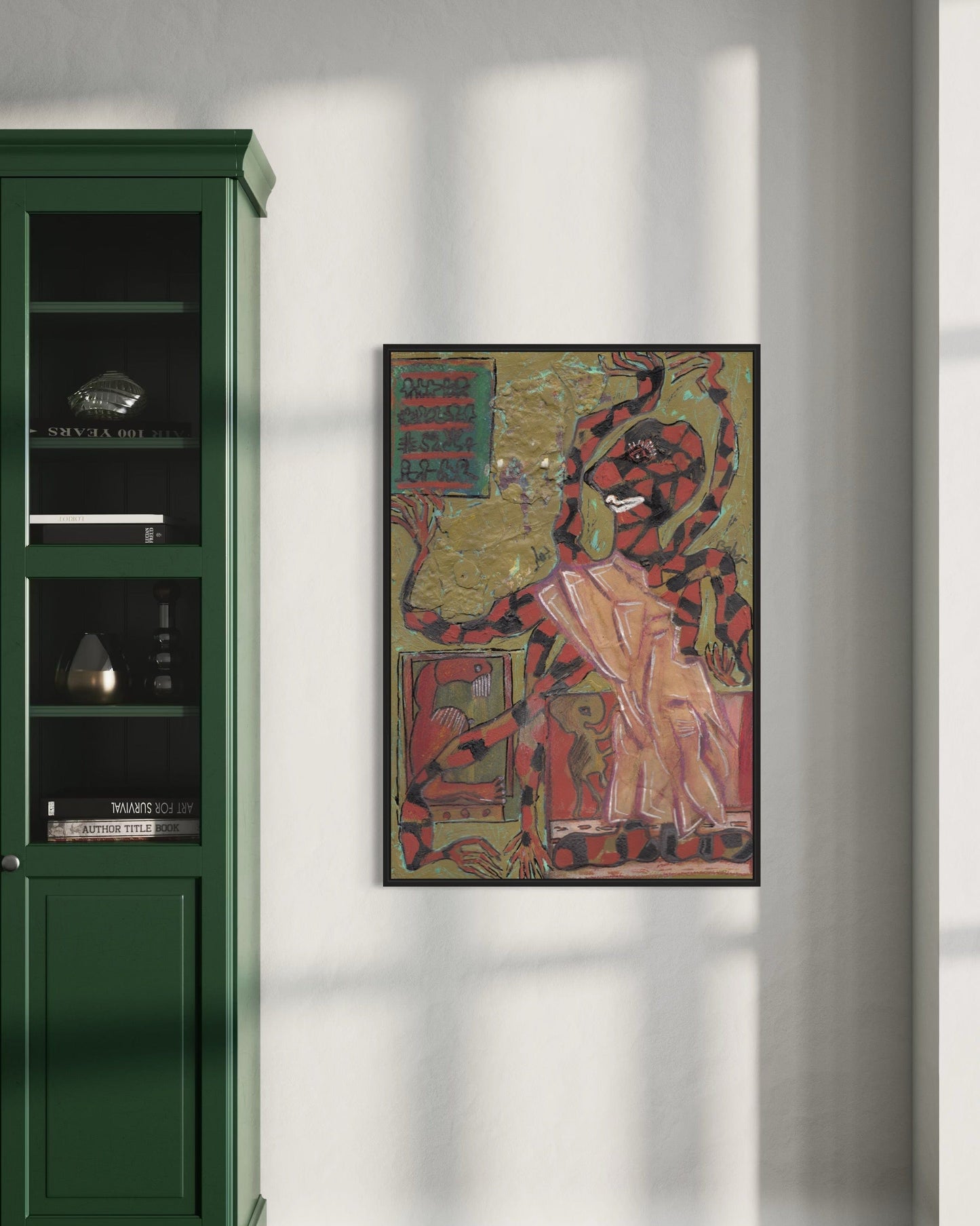 Framed artwork on a wall next to a green cabinet