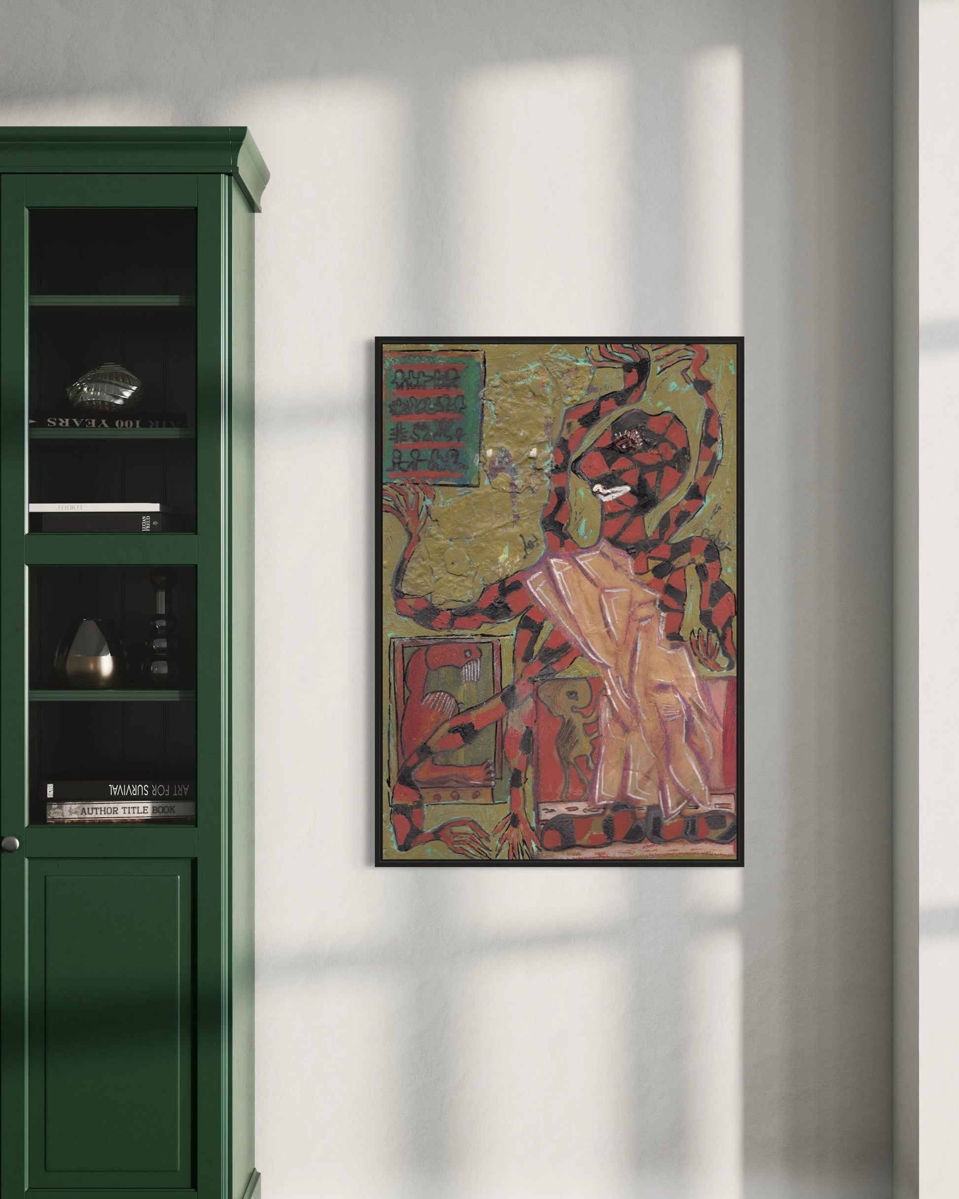 Framed artwork on a wall next to a green cabinet