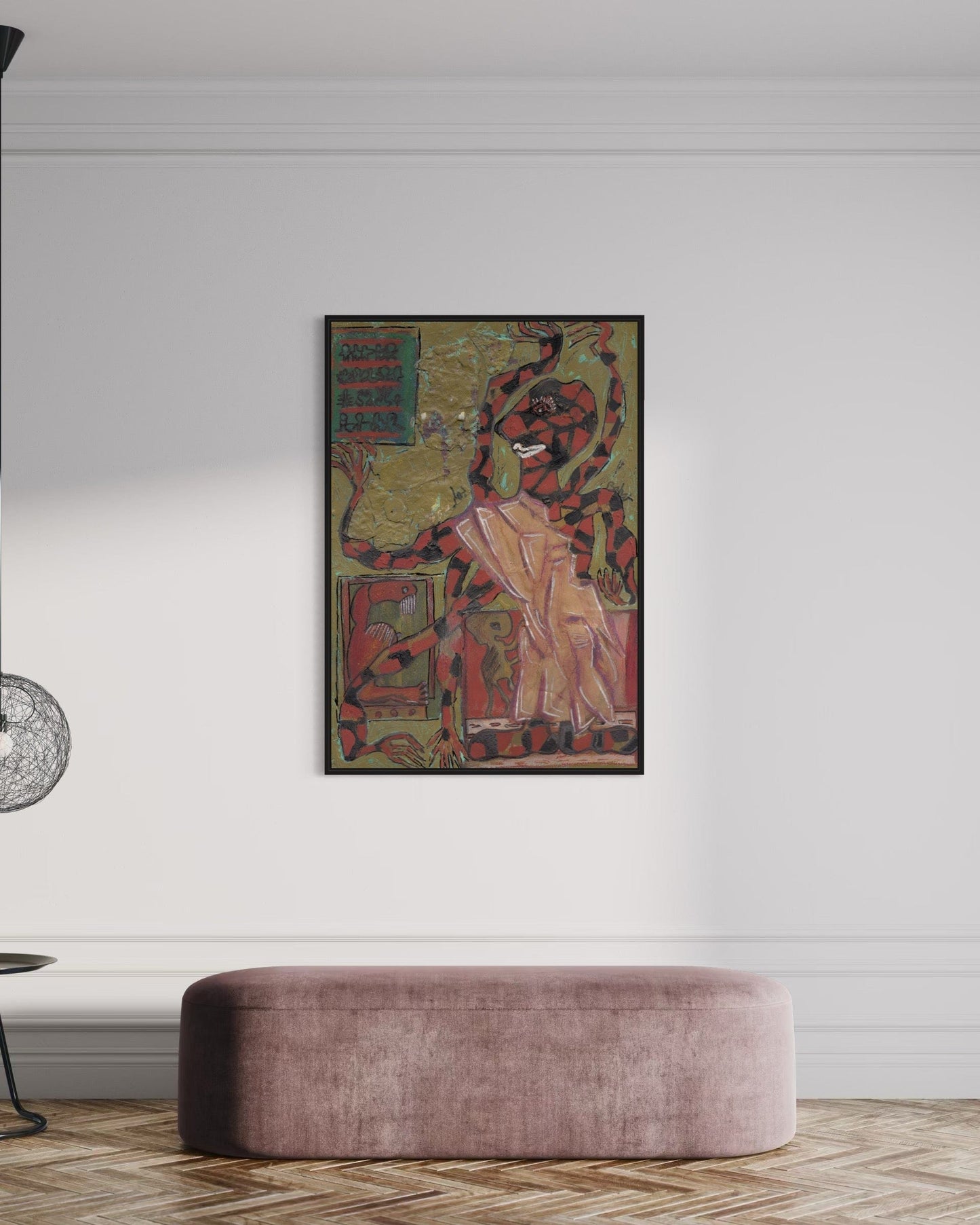 Framed artwork on a wall above a modern pink ottoman in a room.