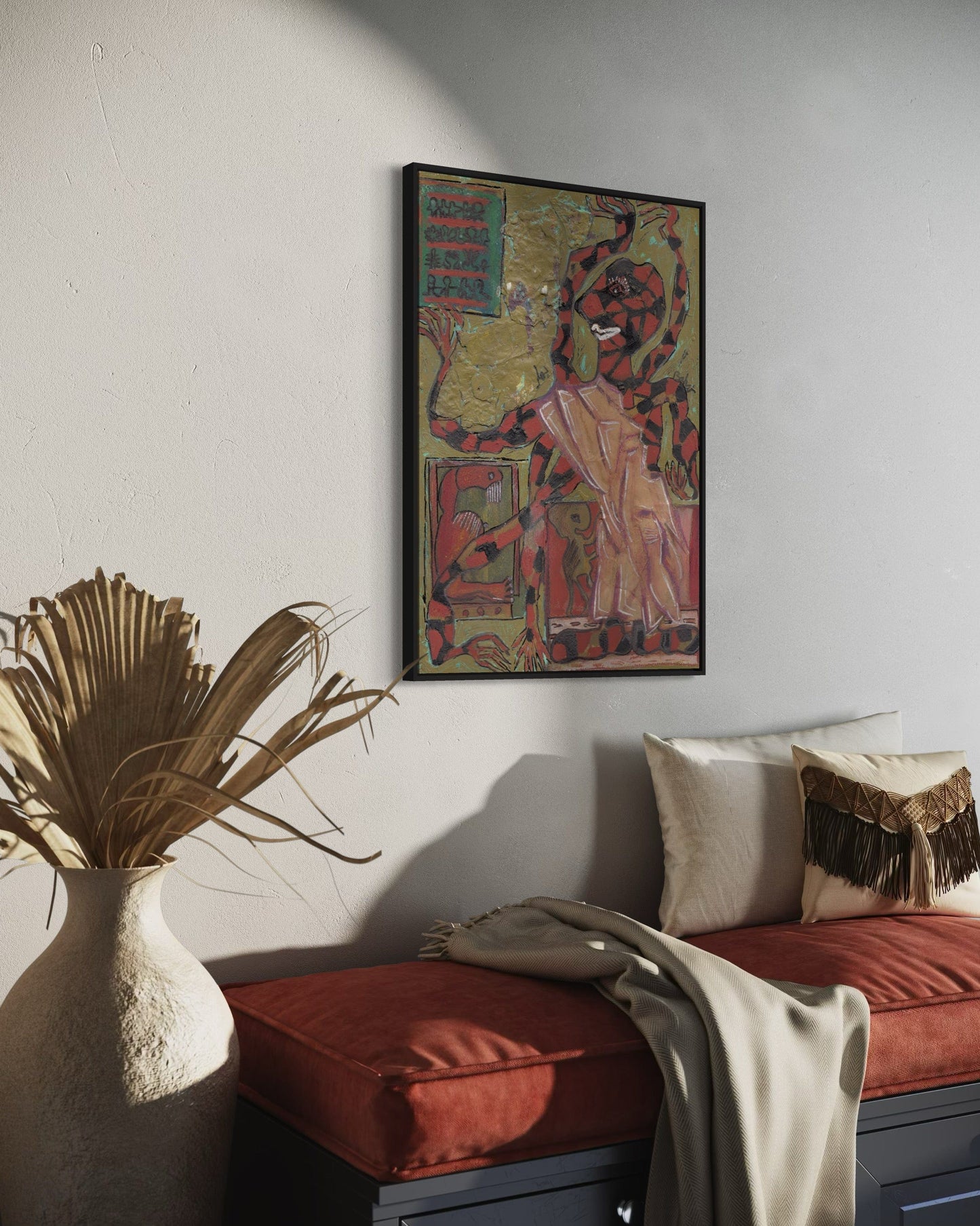 Decorative interior with a colorful framed artwork on the wall, a red cushioned bench, and a vase with dried plants.