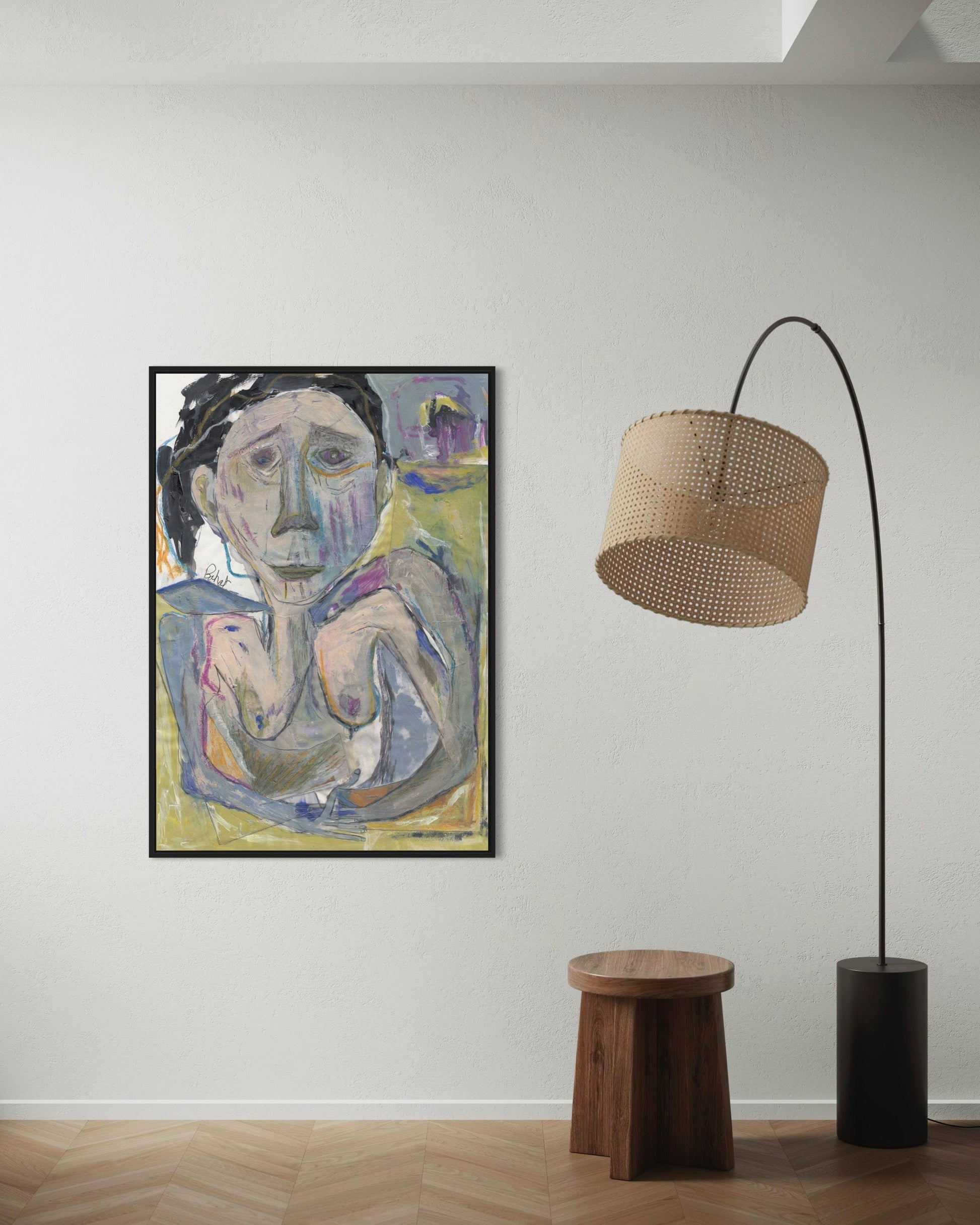 Framed abstract painting on a wall with a wooden stool and modern floor lamp below.
