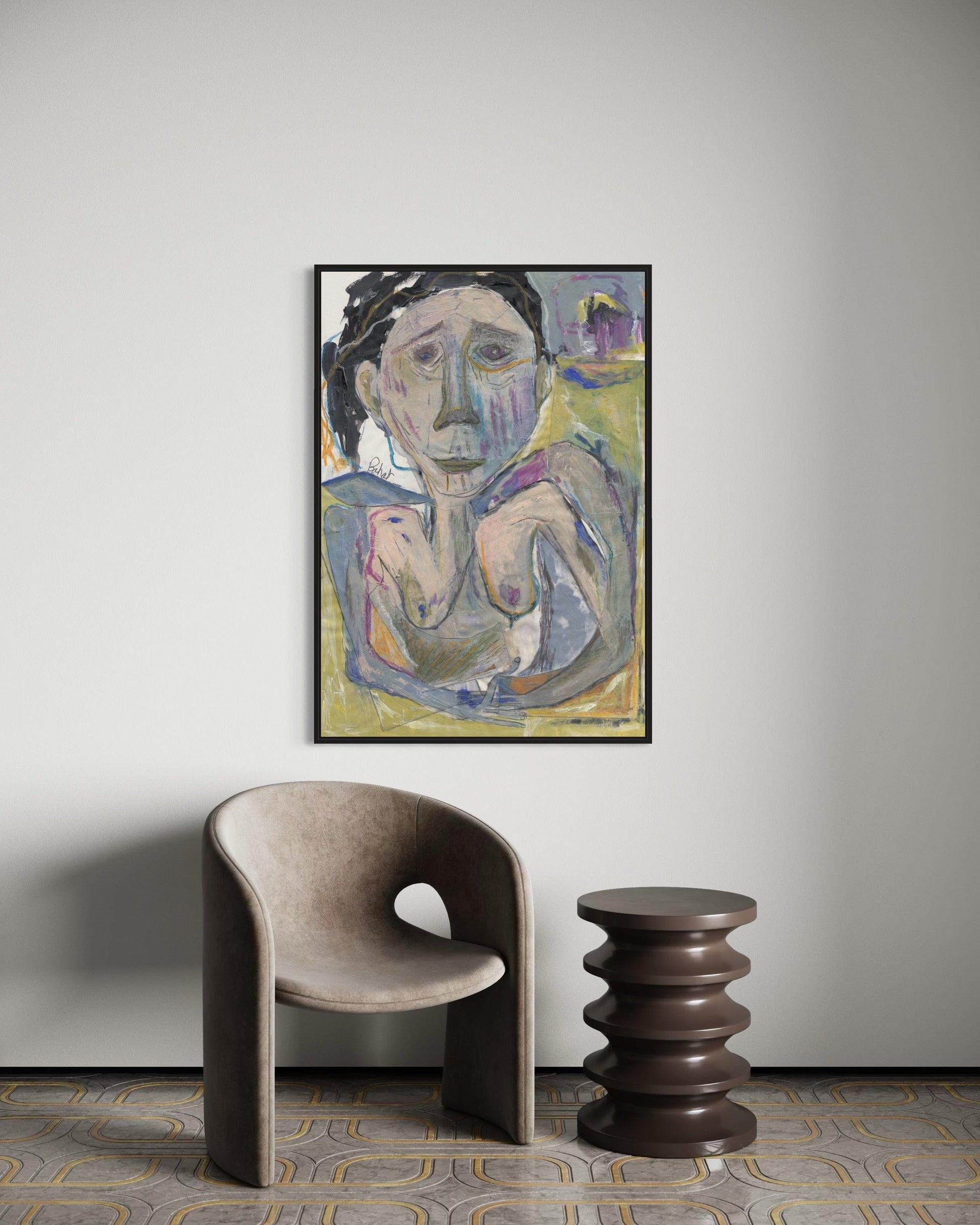 Framed abstract painting on a wall with a modern chair and side table below.