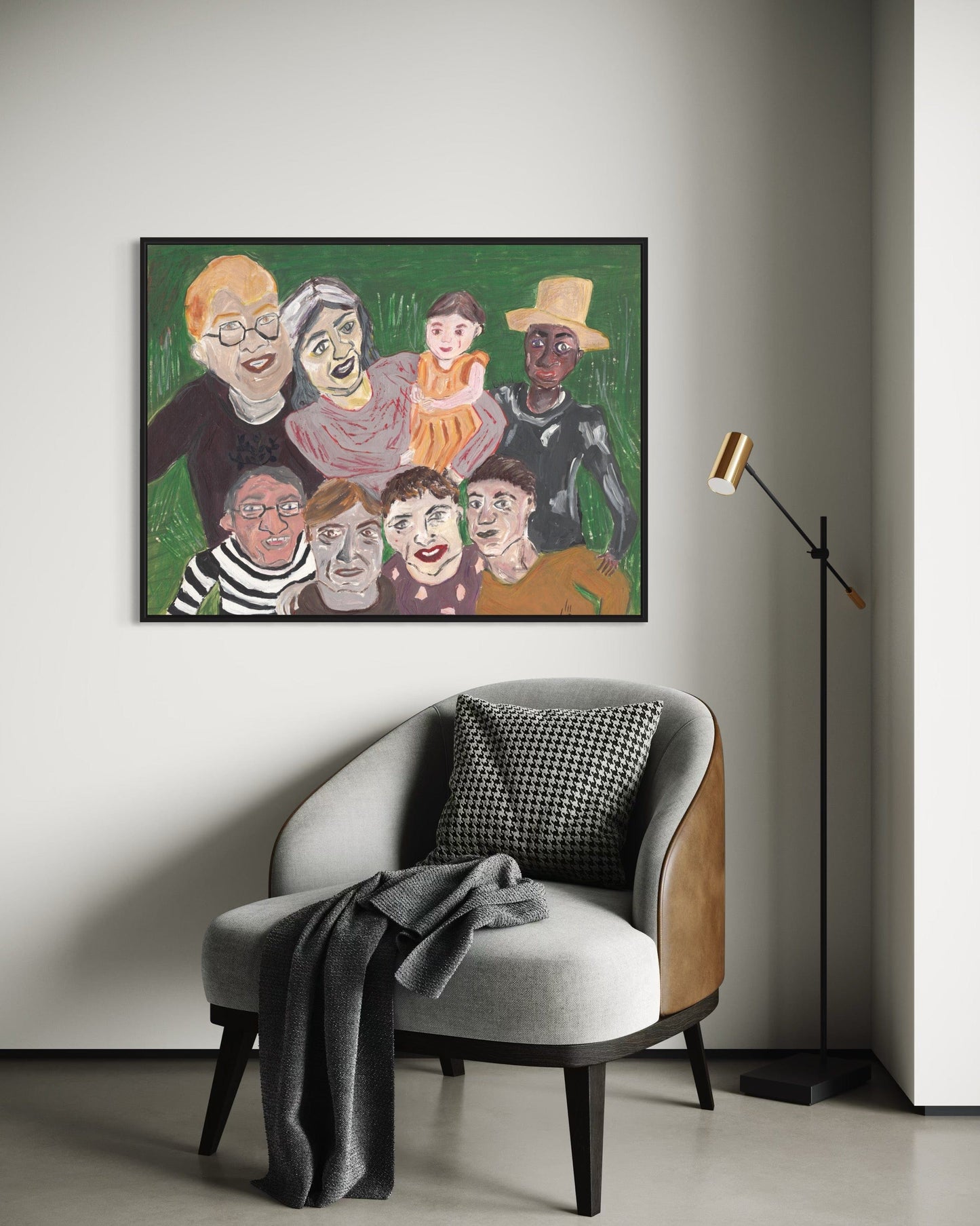 Framed artwork of a family on a wall above a chair with a blanket.