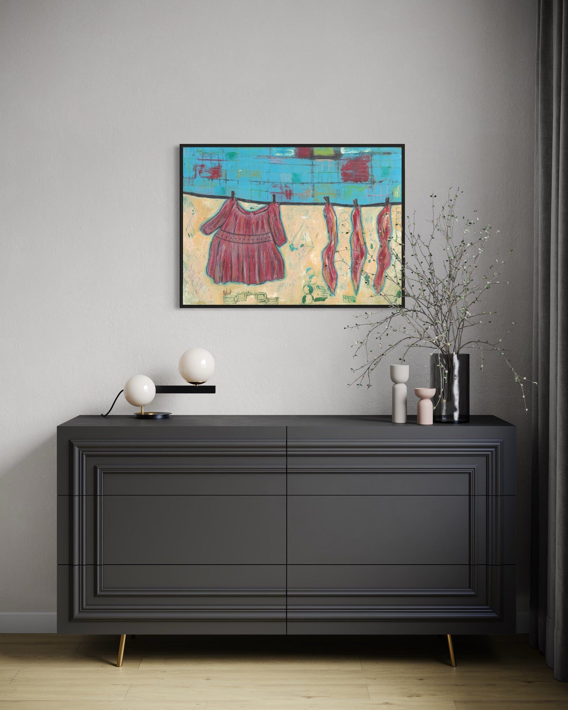 Modern interior with a black dresser, abstract painting, and decorative items.