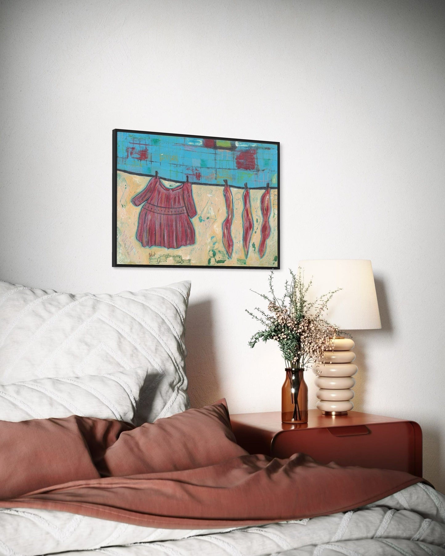 Bedroom with a painting on the wall, nightstand with lamp, and decorative elements.