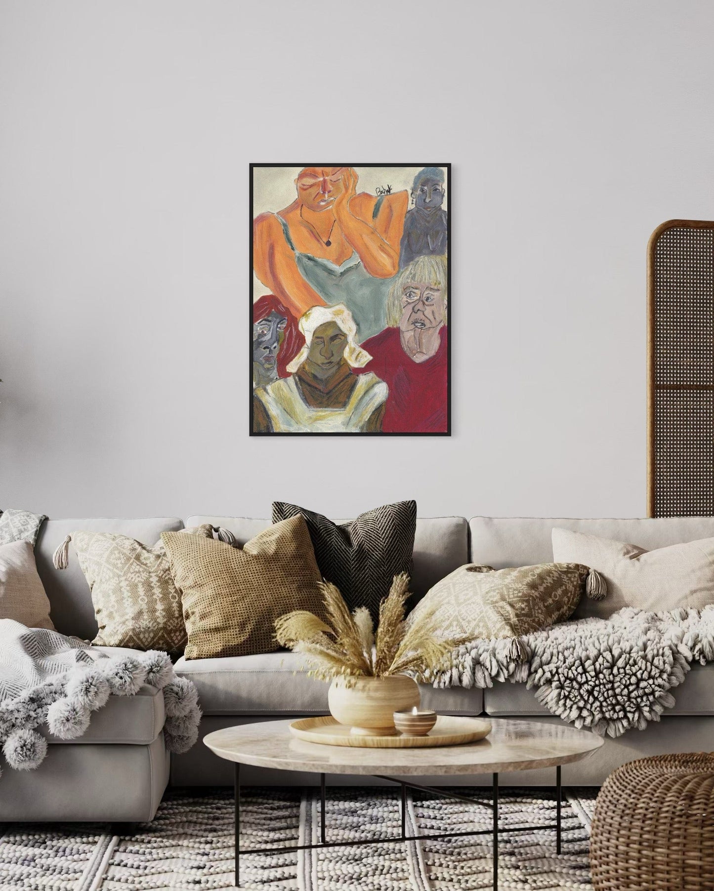 Living room with a gray sofa, decorative pillows, and a framed artwork on the wall.