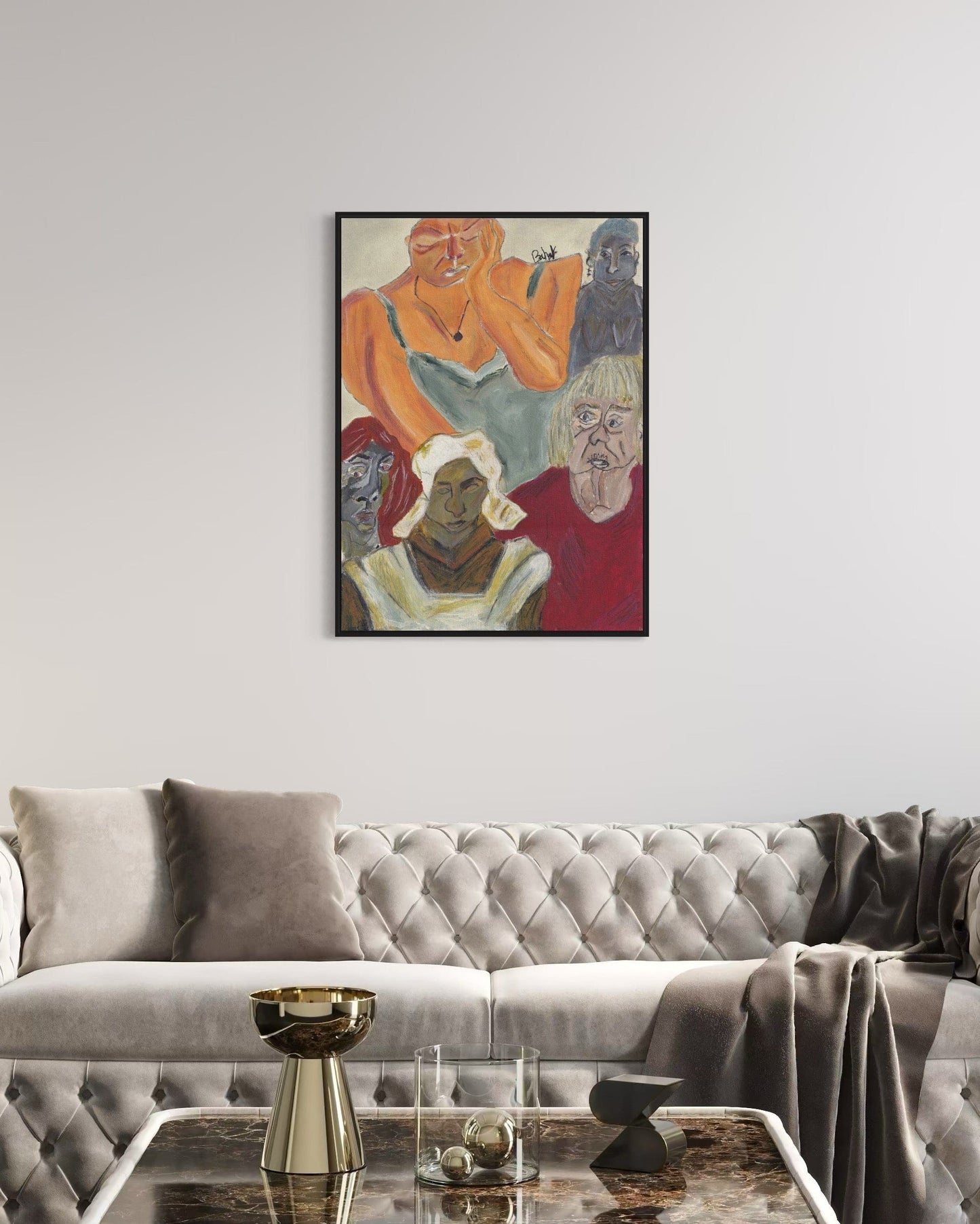 Framed artwork above a gray sofa in a living room setting
