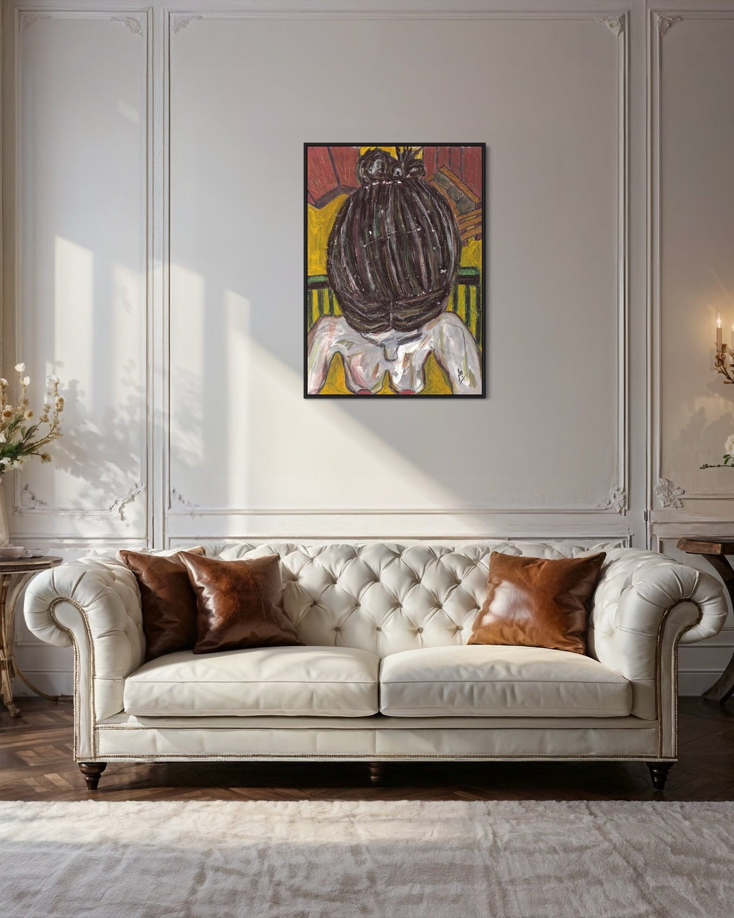 White tufted sofa with brown cushions in a room with a decorative painting on the wall.