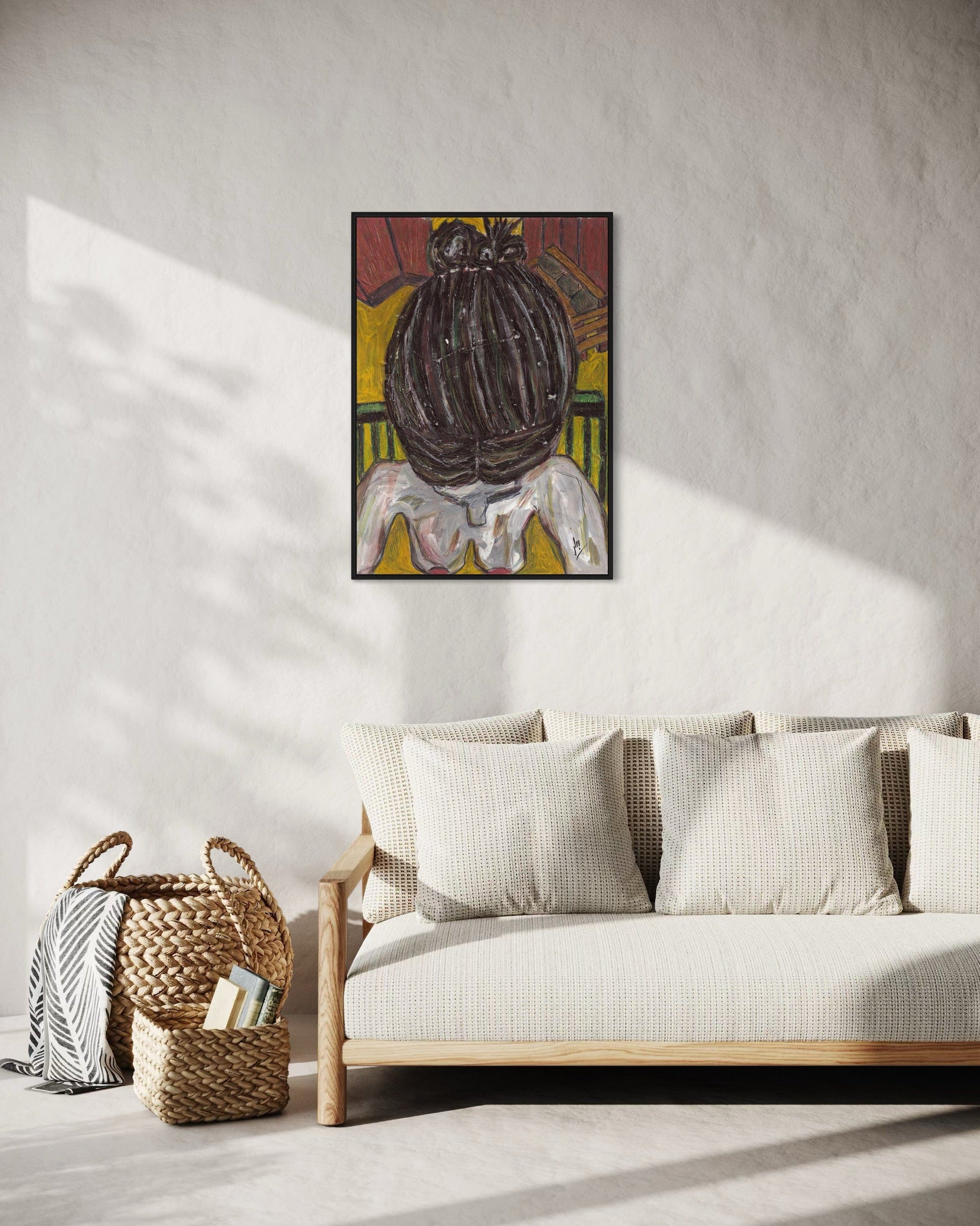 Framed artwork above a sofa in a living room setting