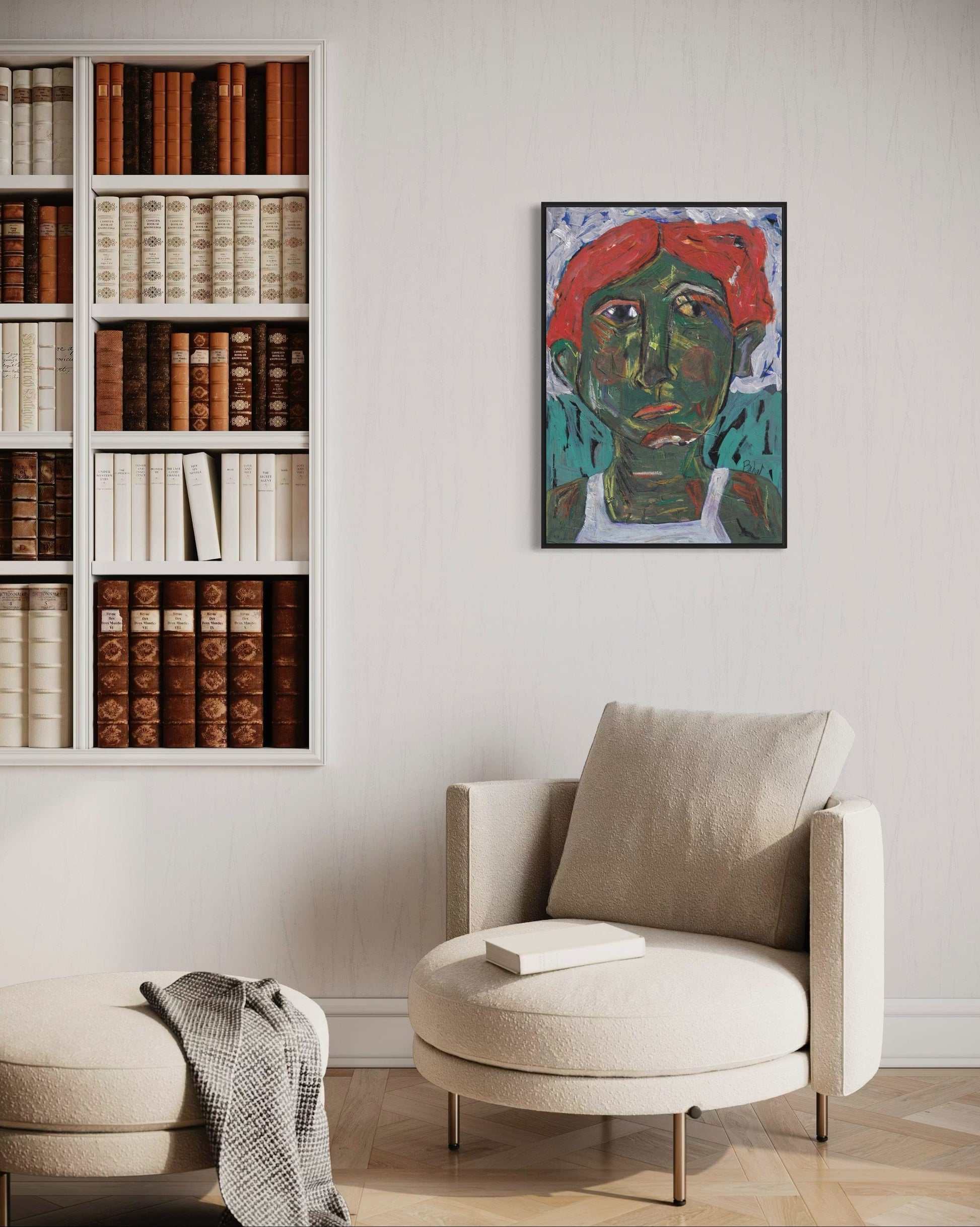 Modern living room with a bookshelf, armchair, and wall art.