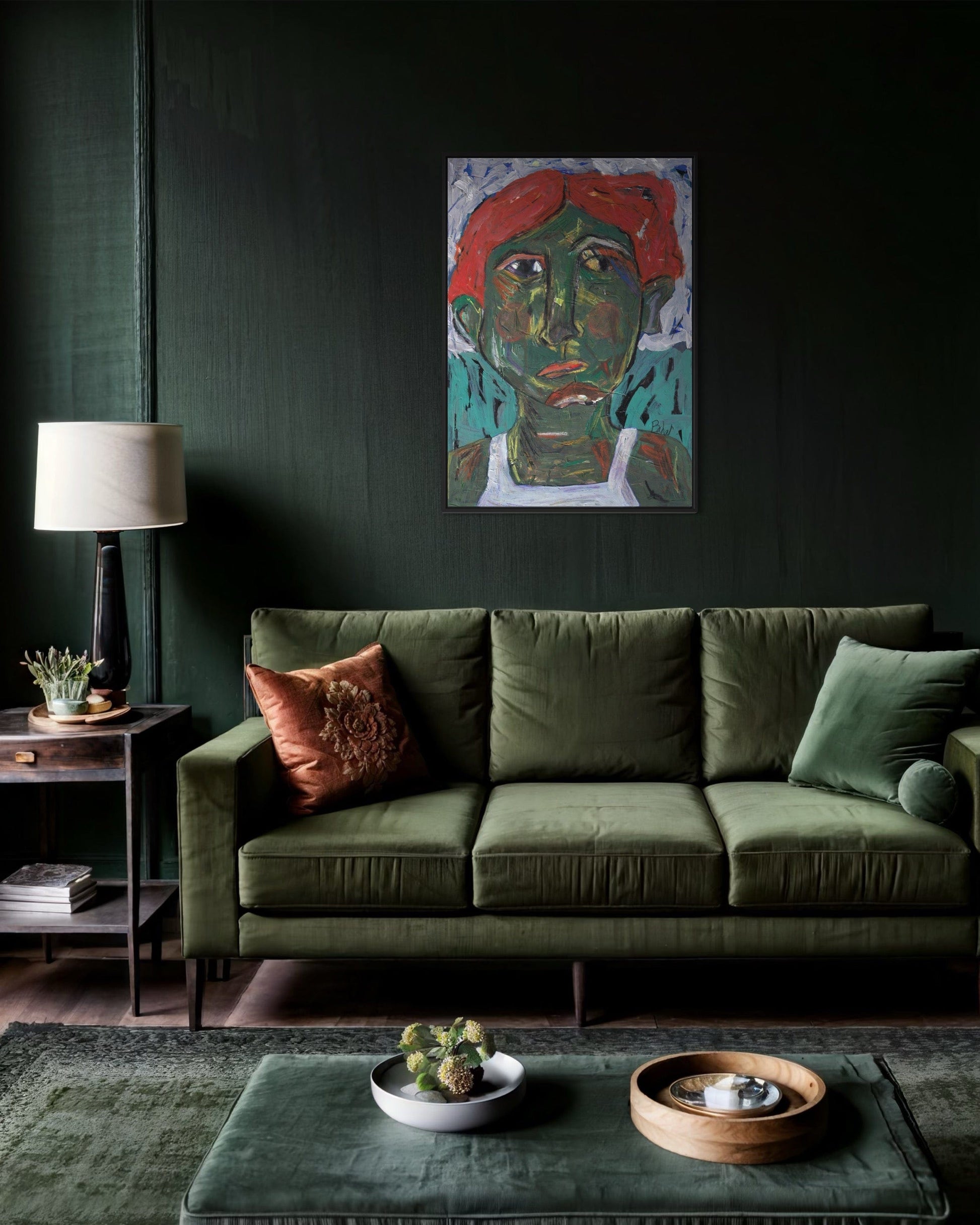 Green sofa in a living room with a dark wall, colorful painting, and decorative items.