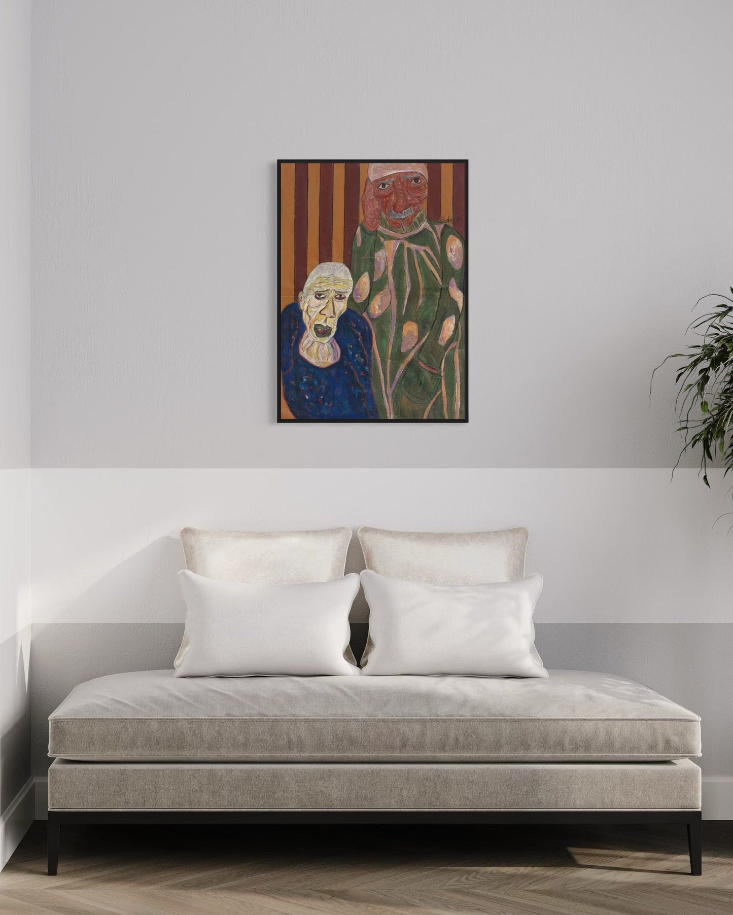Framed artwork above a sofa in a room with a plant