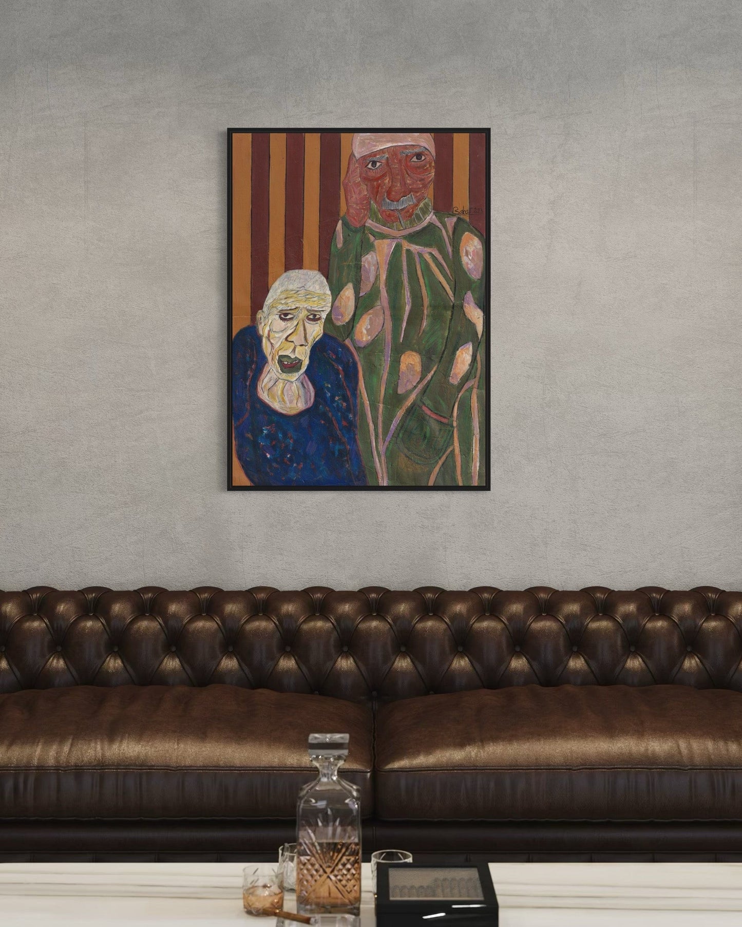 Framed artwork of two stylized figures on a wall above a brown leather sofa.