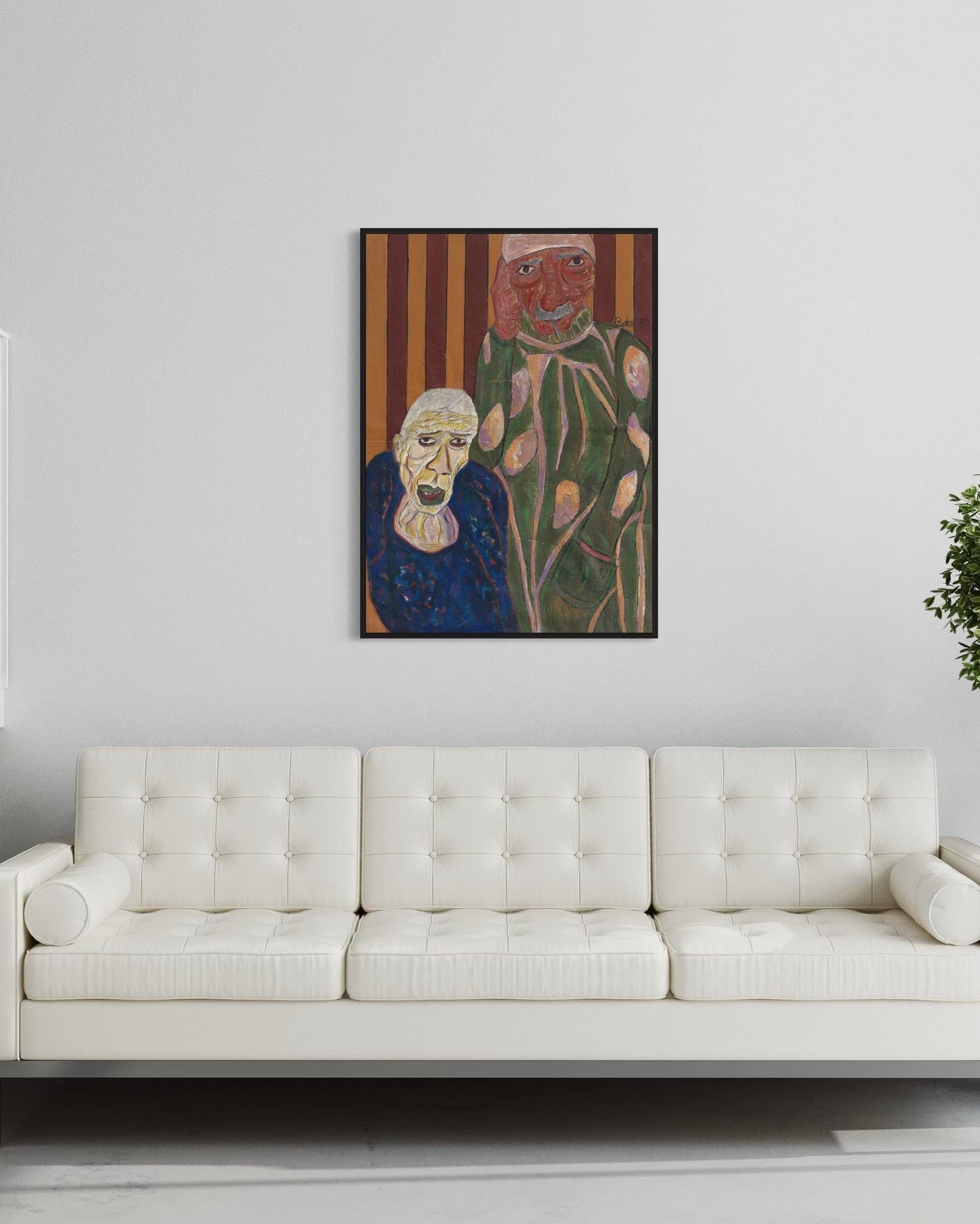 Framed artwork of an elderly woman and a floral figure on a white wall above a white sofa.